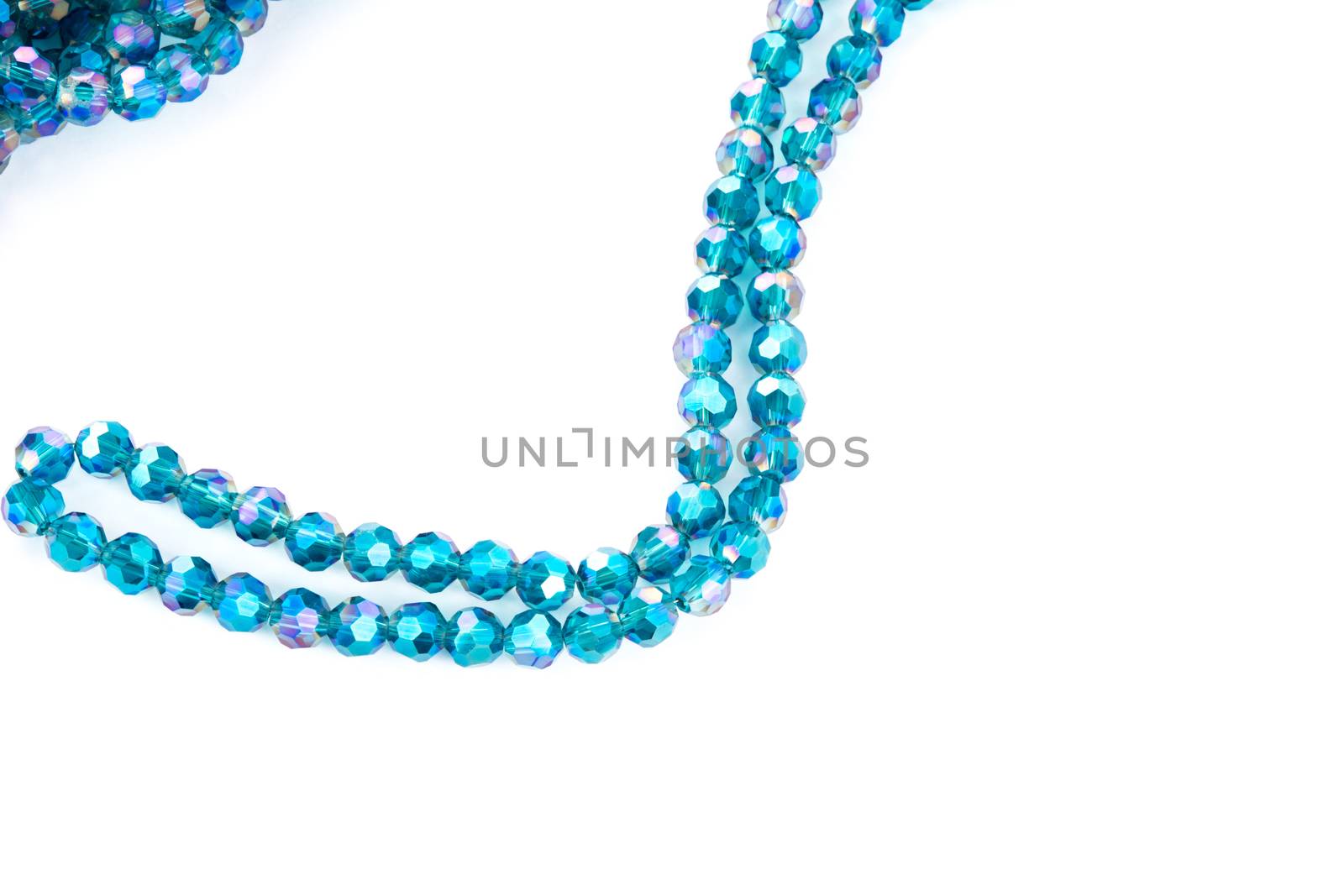 Beautiful emerald blue Glass Sparkle Crystal Isoalted Beads on white background. Use for diy beaded jewelry. Space for text