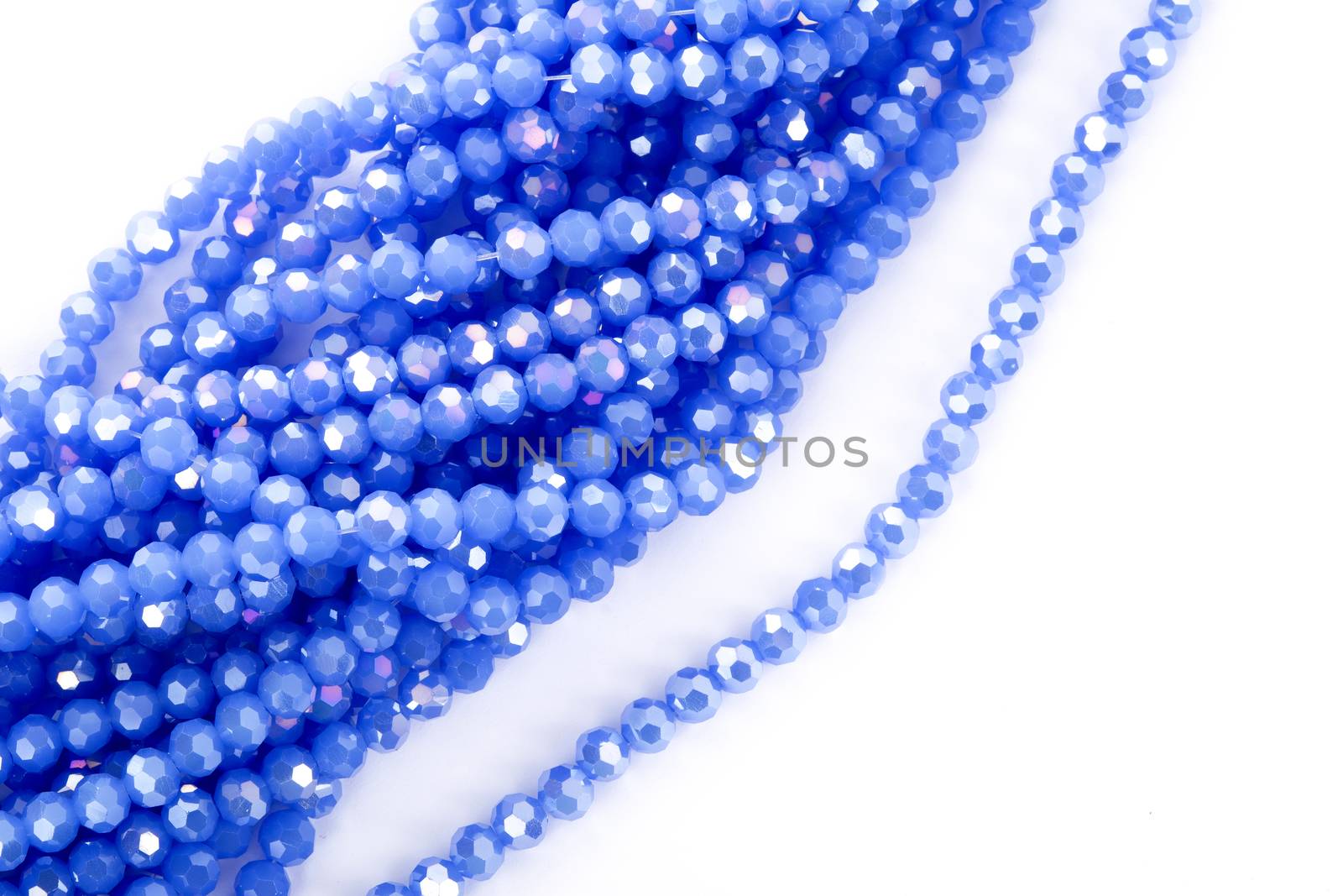 Beautiful blue Glass Sparkle Crystal Isoalted Beads on white background. Use for diy beaded jewelry. Space for text