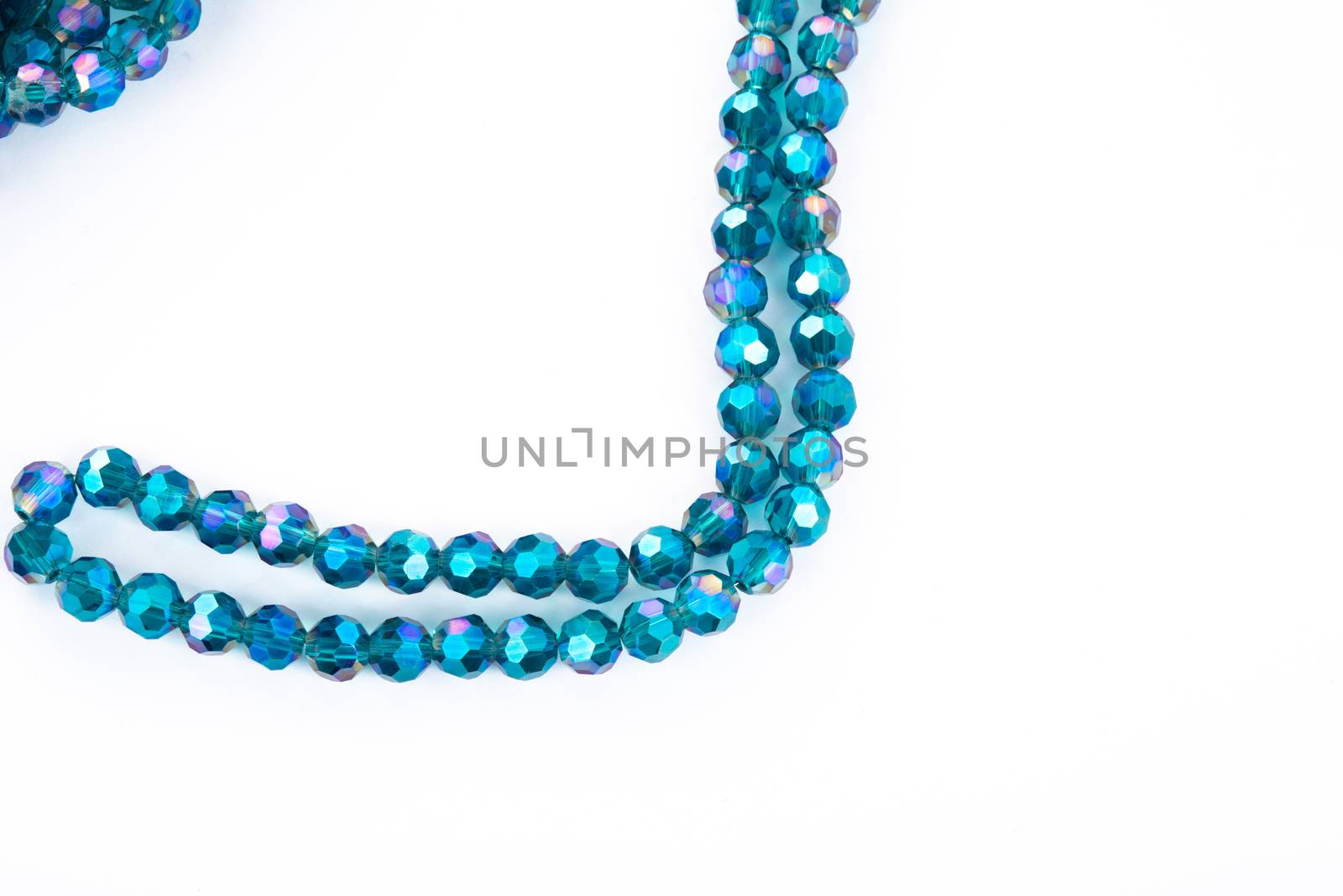 Beautiful emerald Glass Sparkle Crystal Isoalted Beads on white background. Use for diy beaded jewelry. Space for text