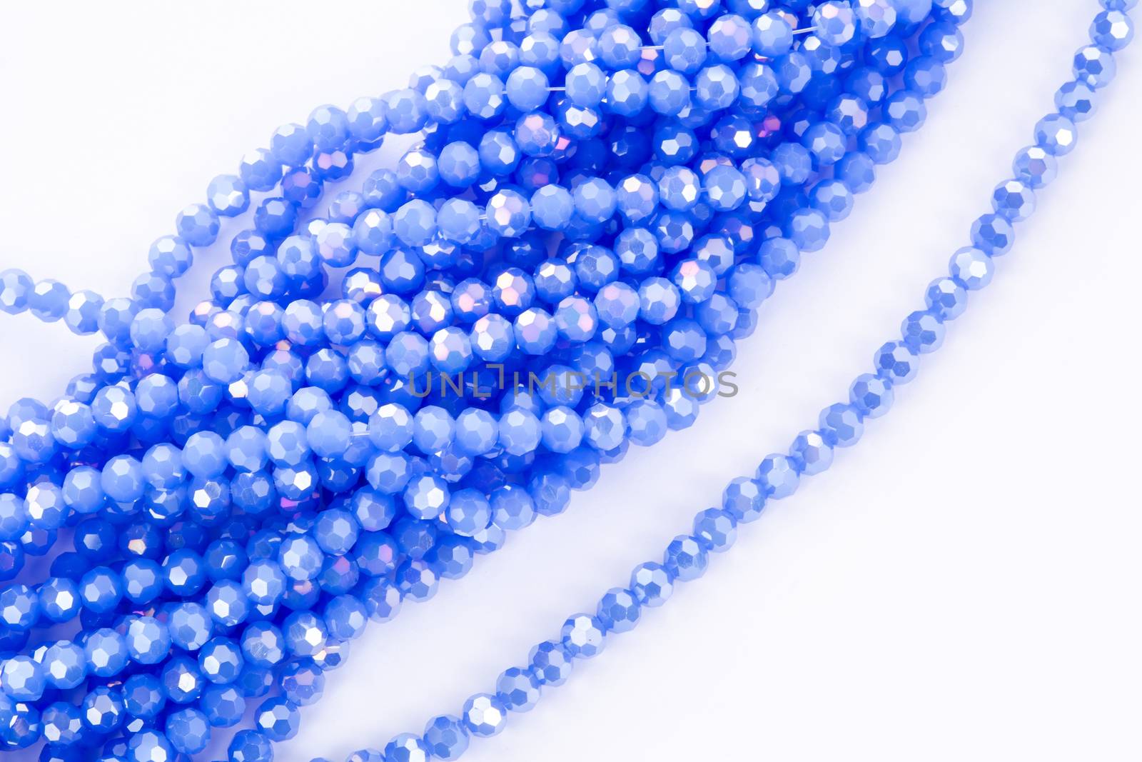 Beautiful blue Glass Sparkle Crystal Isoalted Beads on white background. Use for diy beaded jewelry. Space for text