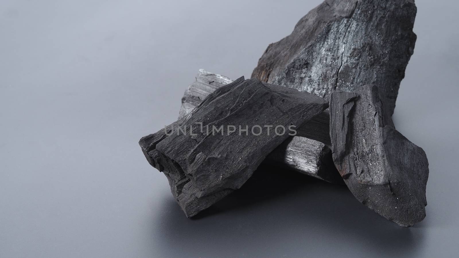 Group of charcoal black color made from real wood in studio close-up shot which use for cooking or absorb odor in room or refrigerator. And use in some cosmetic industry.