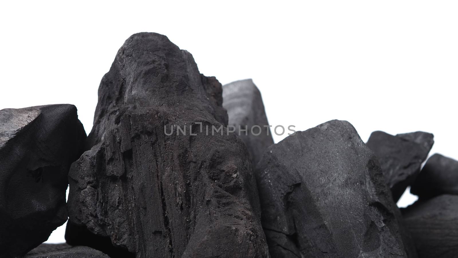 Group of charcoal black color made from real wood in studio close-up shot which use for cooking or absorb odor in room or refrigerator. And use in some cosmetic industry.