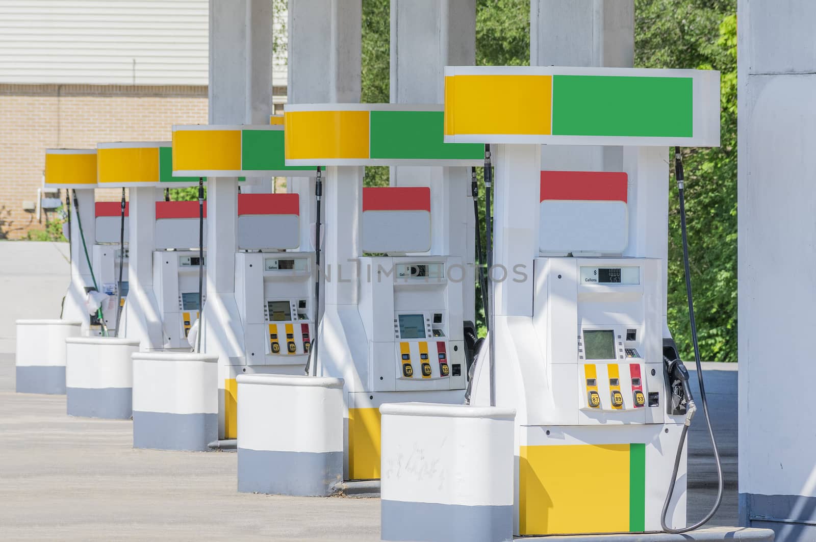 Horizontal shot of a row of fuel pumps with branding removed and colors changed.

