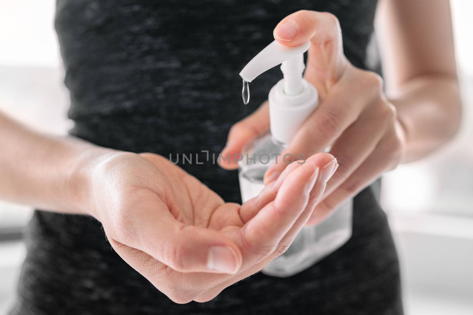 Hand sanitizer bottle disinfecting hands hygiene. Coronavirus rubbing with alcohol gel for COVID 19 outbreak spreading prevention by Maridav
