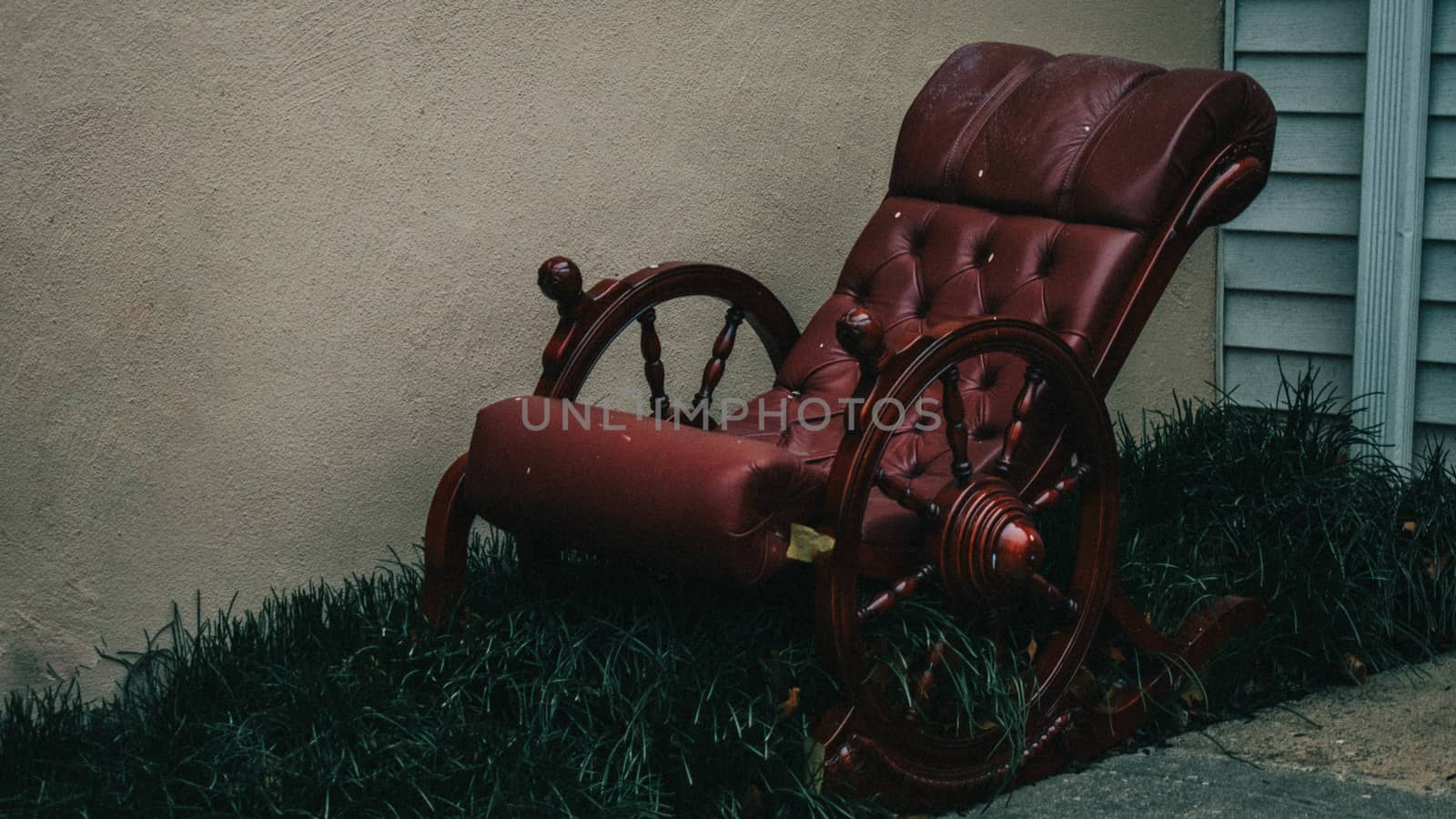 An Old-Fashioned Red Rocking Chair Sitting in a Patch of Grass N by bju12290