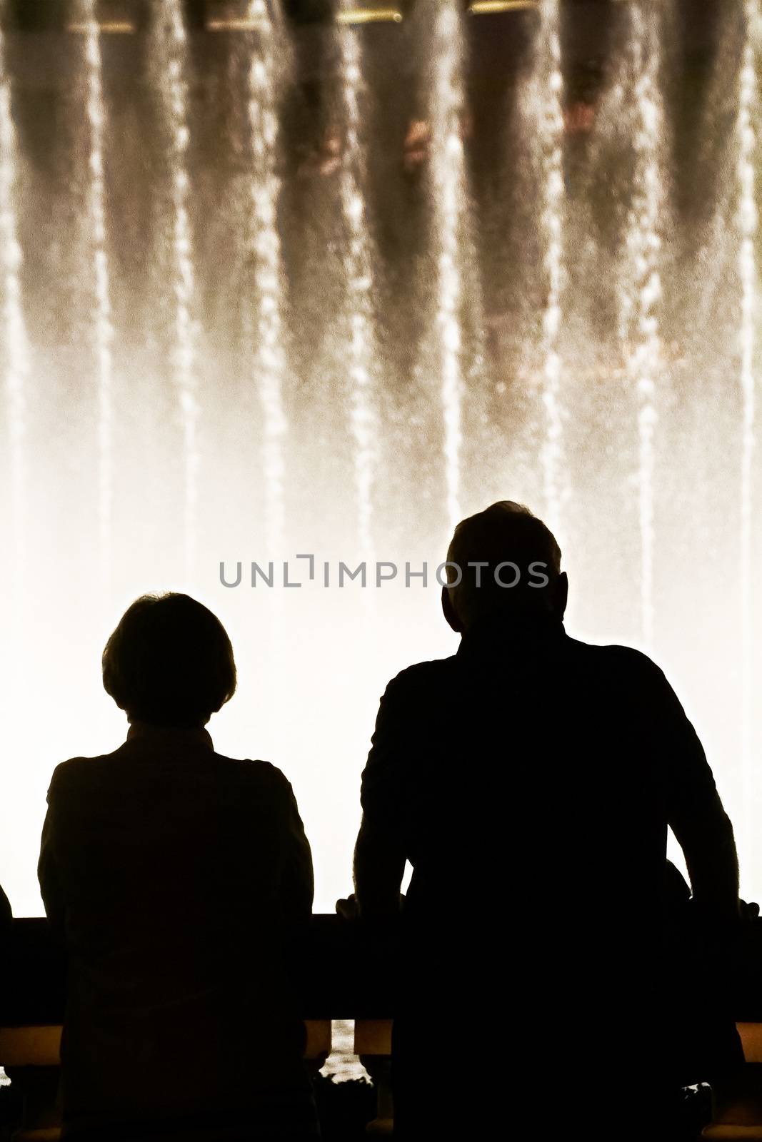 Night scene with silhouettes of people admiring the Bellagio fountains spectacle at Las Vegas by USA-TARO