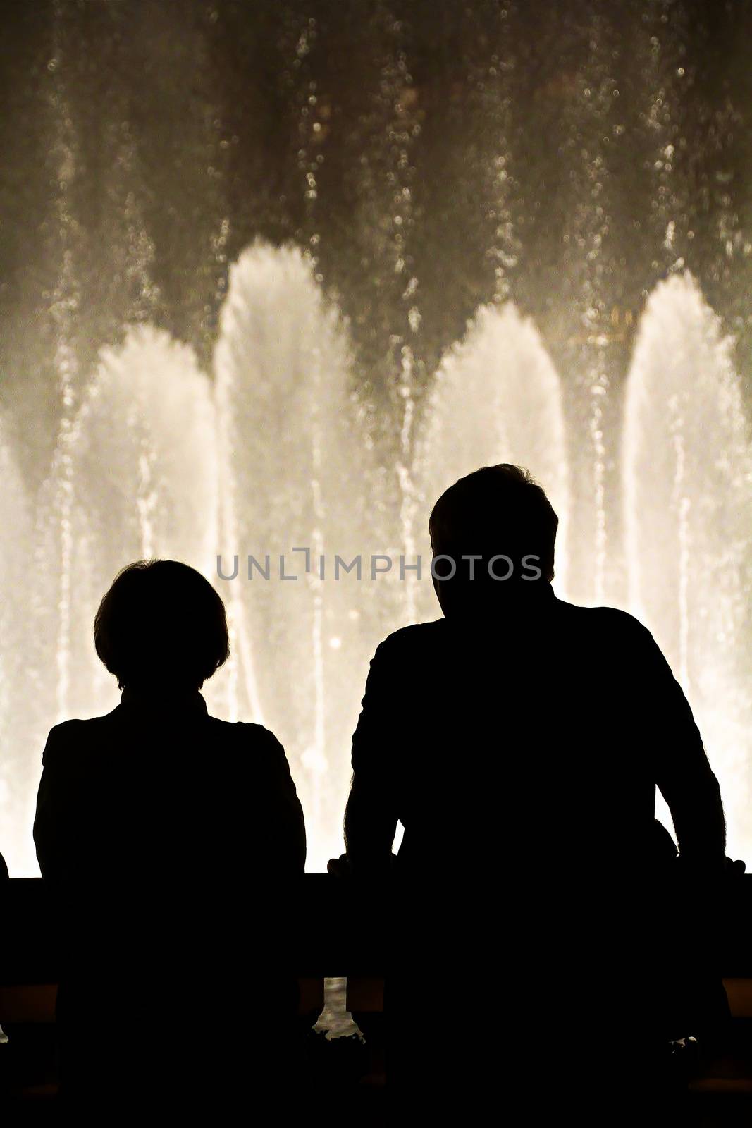 Night scene with silhouettes of people admiring the Bellagio fountains spectacle at Las Vegas by USA-TARO