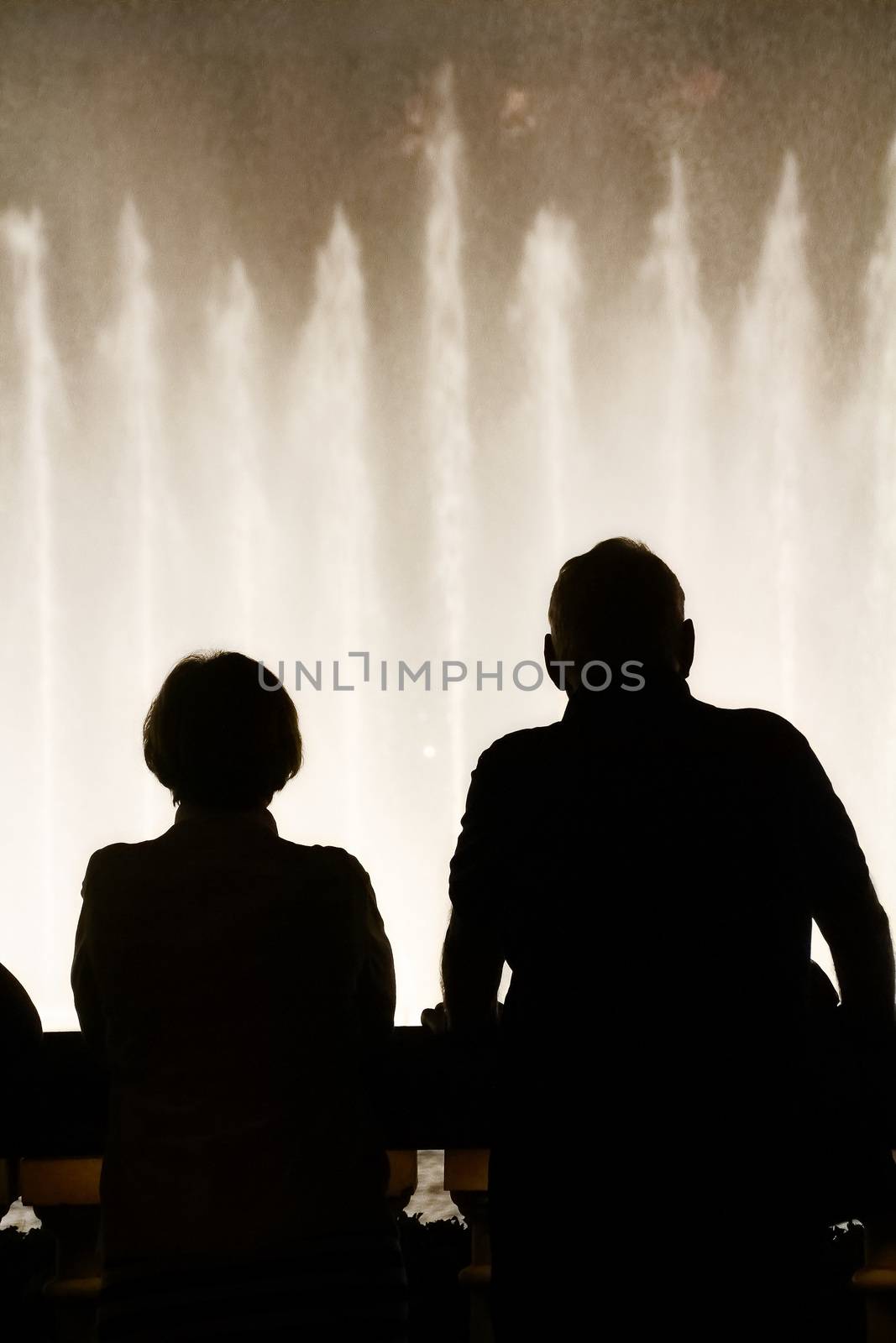 Night scene with silhouettes of people admiring the Bellagio fountains spectacle at Las Vegas by USA-TARO