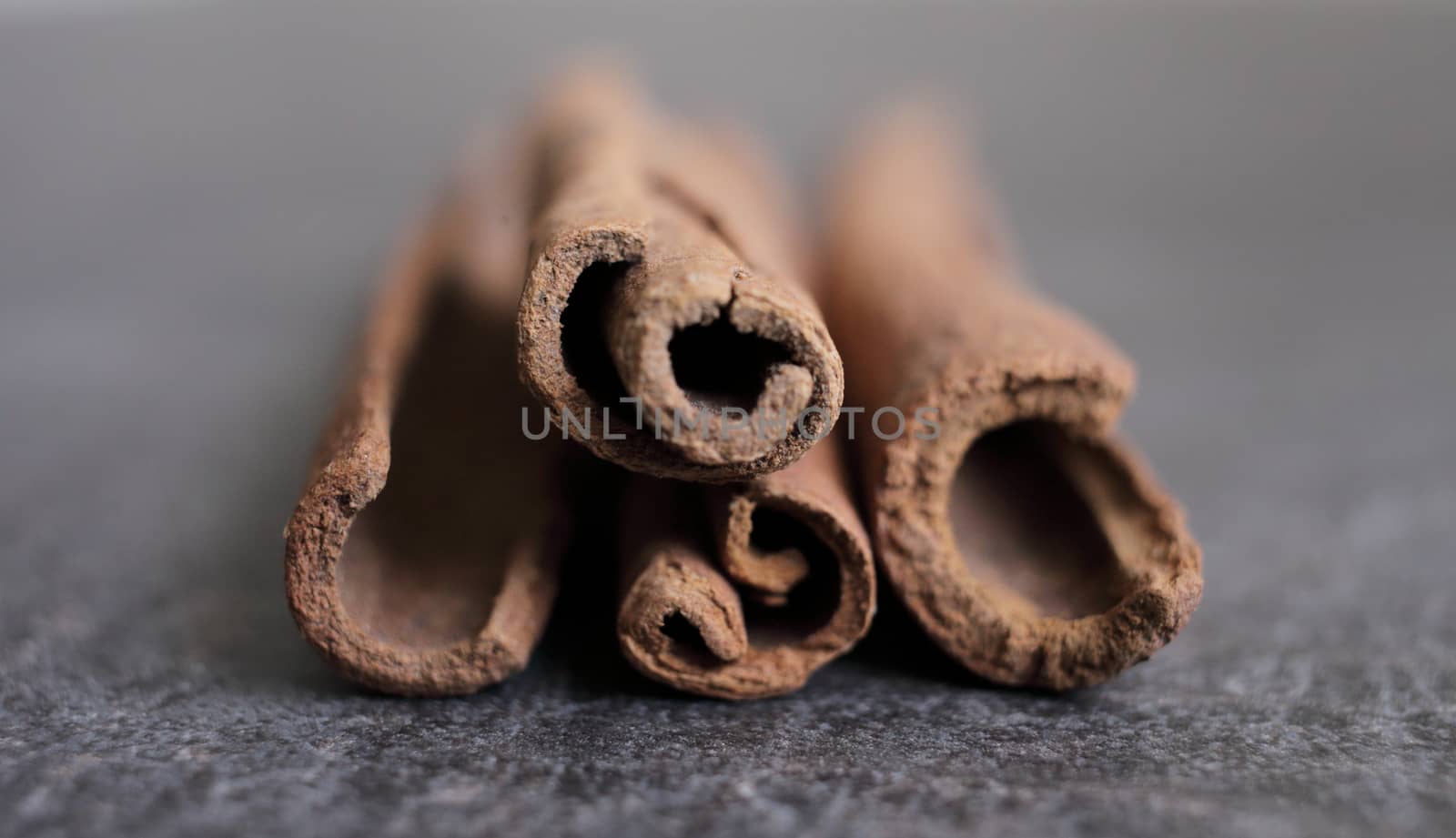 Scented cinnamon sticks on gray concrete countertop by selinsmo