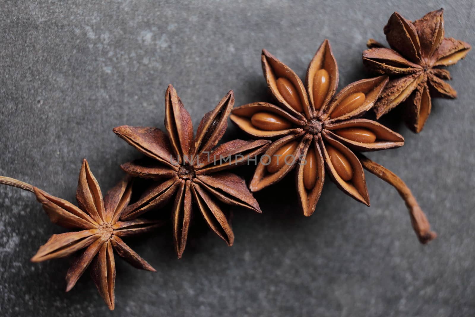 Fragrant star anise stars on a gray concrete countertop. High quality photo