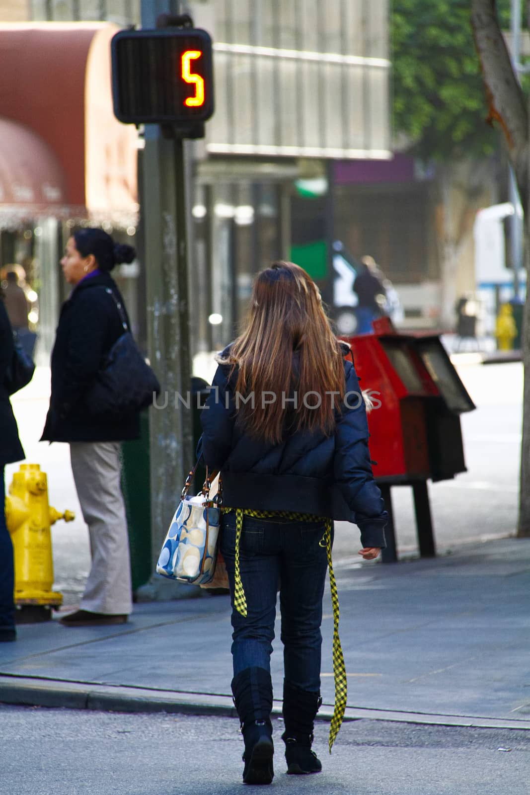 Los Angeles,CA/USA - Nov,03,2018 : Back view of young girls walking at an intersection and women waiting for a signal by USA-TARO