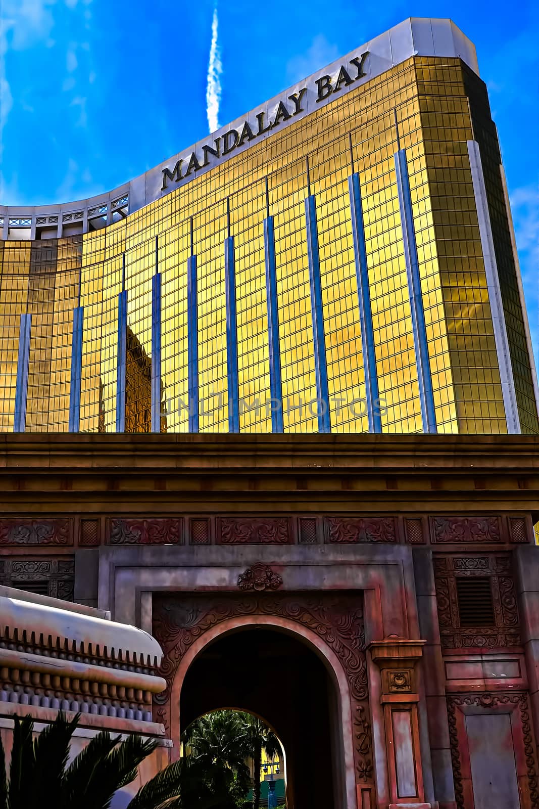 Las Vegas, NV/USA - Sep 15, 2018; Enormous Mandalay Bay Hotel Resort and Casino Las Vegas with beautifully landscaped entrance to modern architectural gold glass facade of building.
