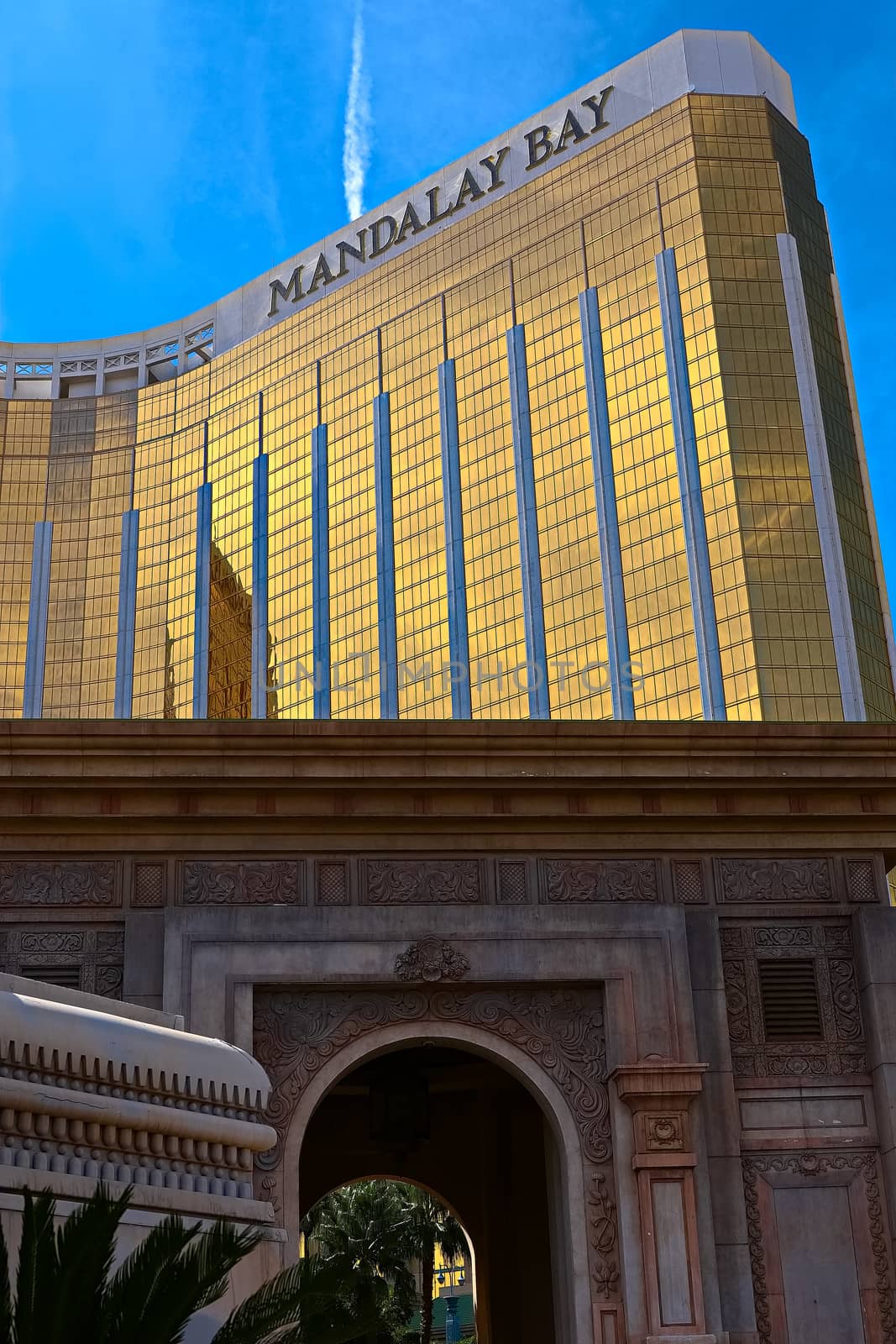 Las Vegas, NV/USA - Sep 15, 2018; Enormous Mandalay Bay Hotel Resort and Casino Las Vegas with beautifully landscaped entrance to modern architectural gold glass facade of building. by USA-TARO