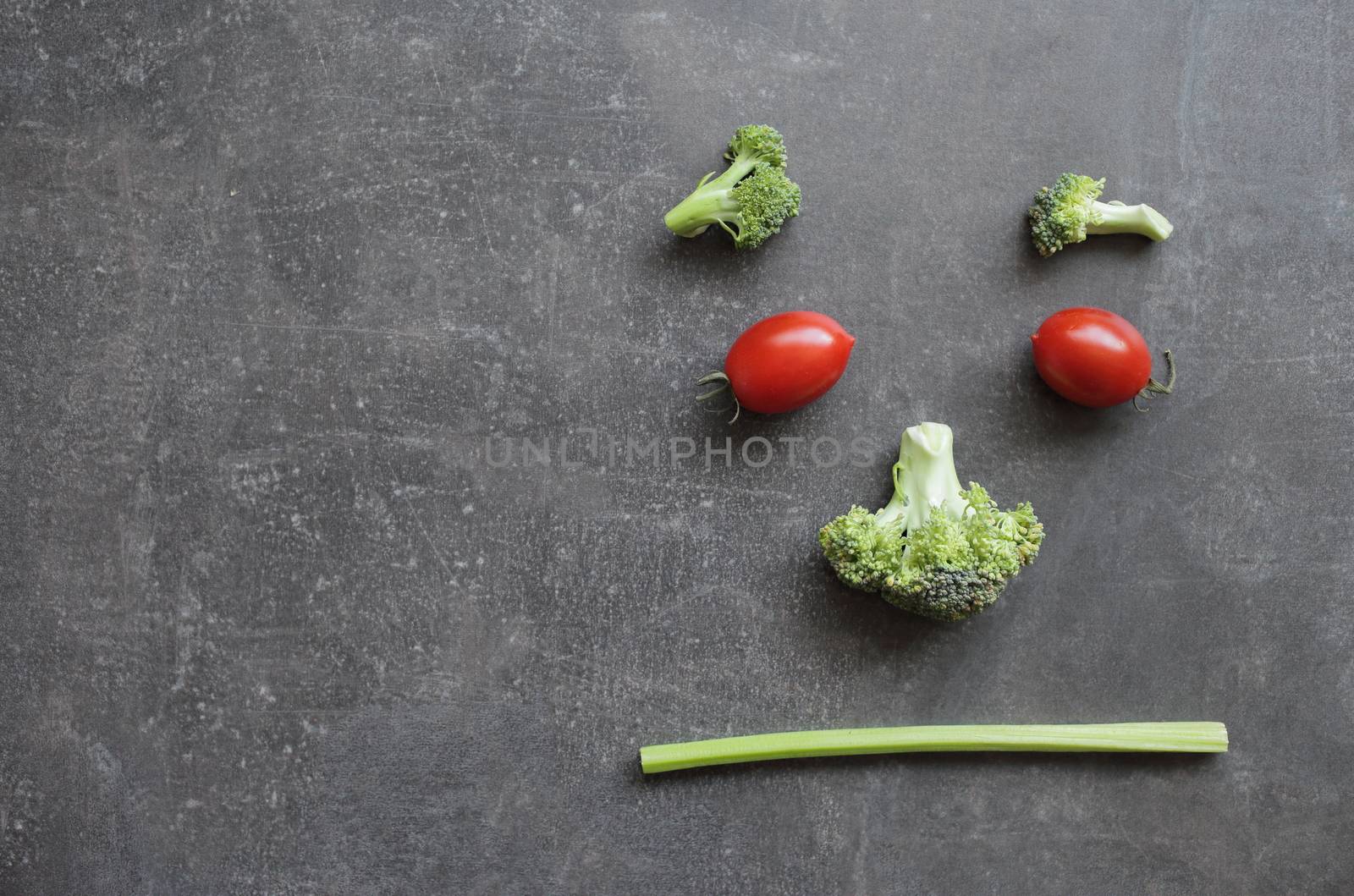 Displeased emoticon of fresh vegetables cherry tomatoes broccoli and celery by selinsmo