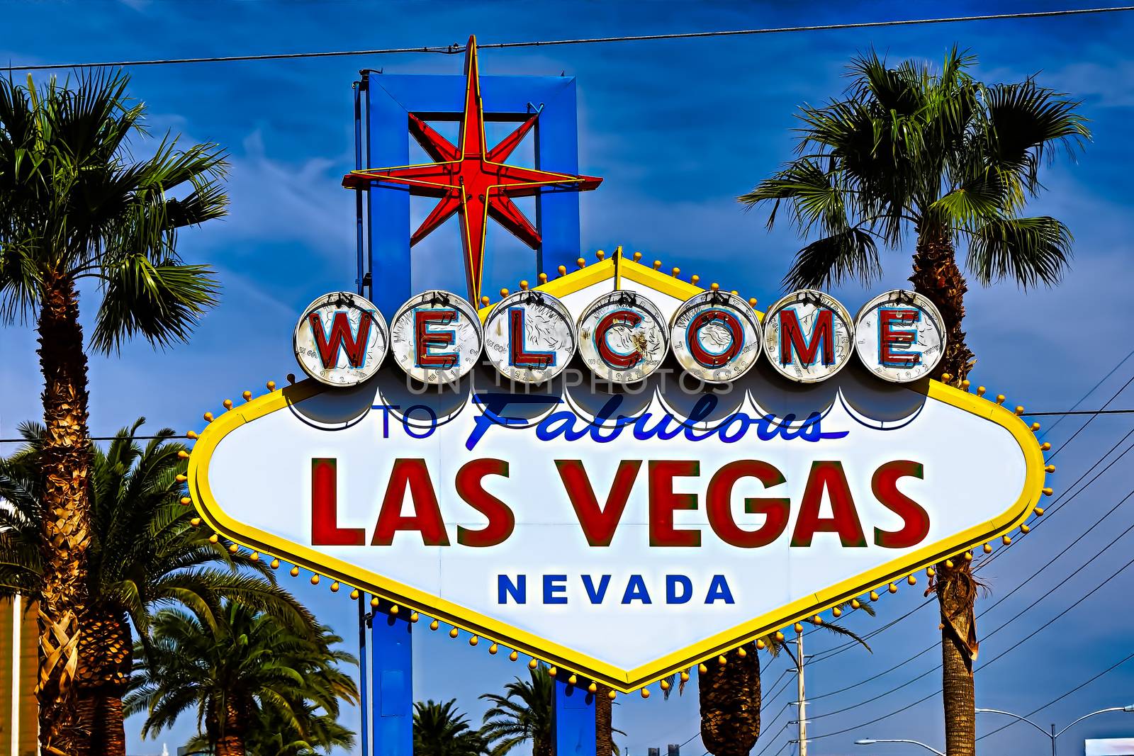 he Welcome to Fabulous Las Vegas sign on bright sunny day in Las Vegas.Welcome to Never Sleep city Las Vegas, Nevada Sign with the heart of Las Vegas scene in the background.