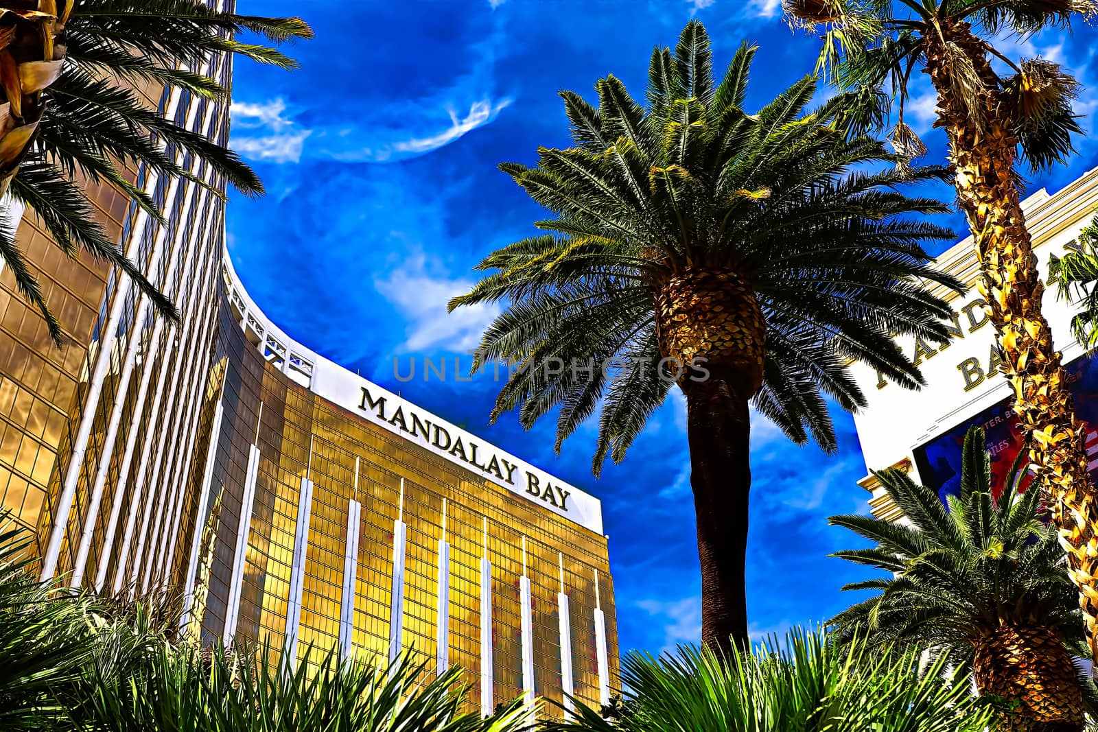 Las Vegas, NV/USA - Sep 15, 2018; Enormous Mandalay Bay Hotel Resort and Casino Las Vegas with beautifully landscaped entrance to modern architectural gold glass facade of building.