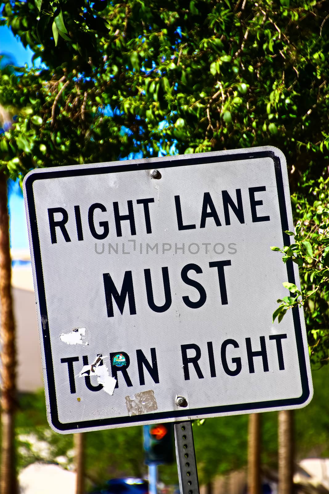 Sign of Right lane must turn right.Close up on a "Right Lane Must Turn Right" at an intersection, in a transportation background.Signpost in public street, "Right Lane Must Turn Right"