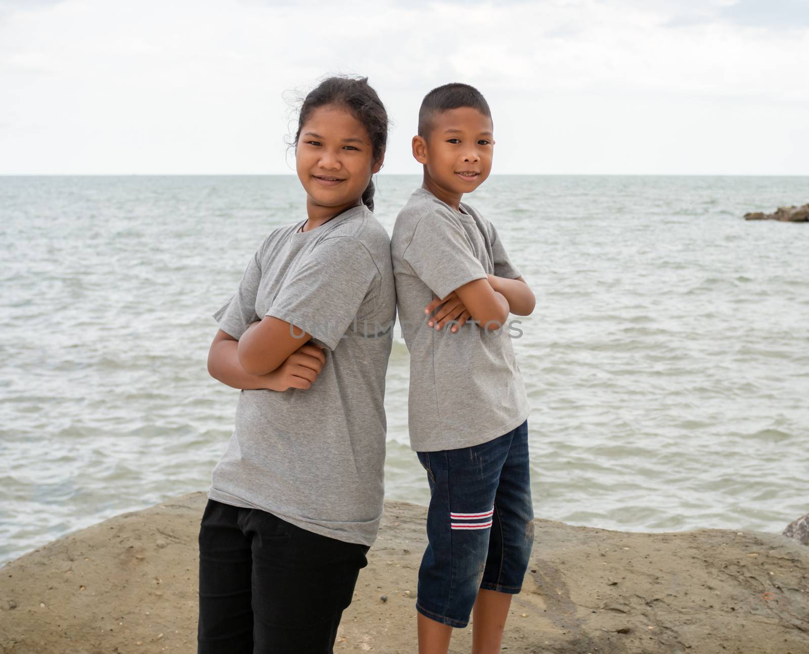 Sister and brother Stand on the sea background