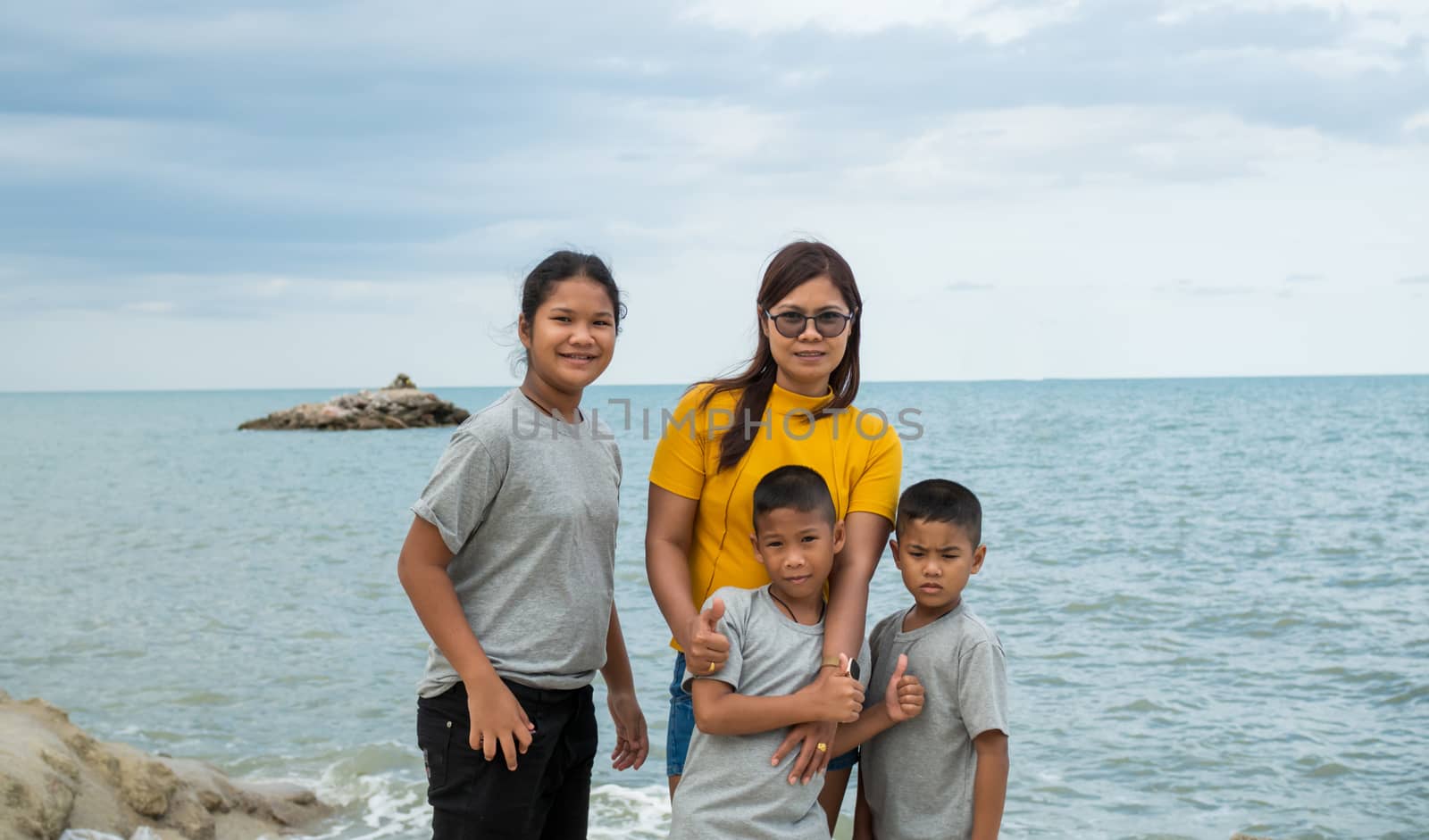 Portraits of mothers and children standing on the rock with the  by Unimages2527