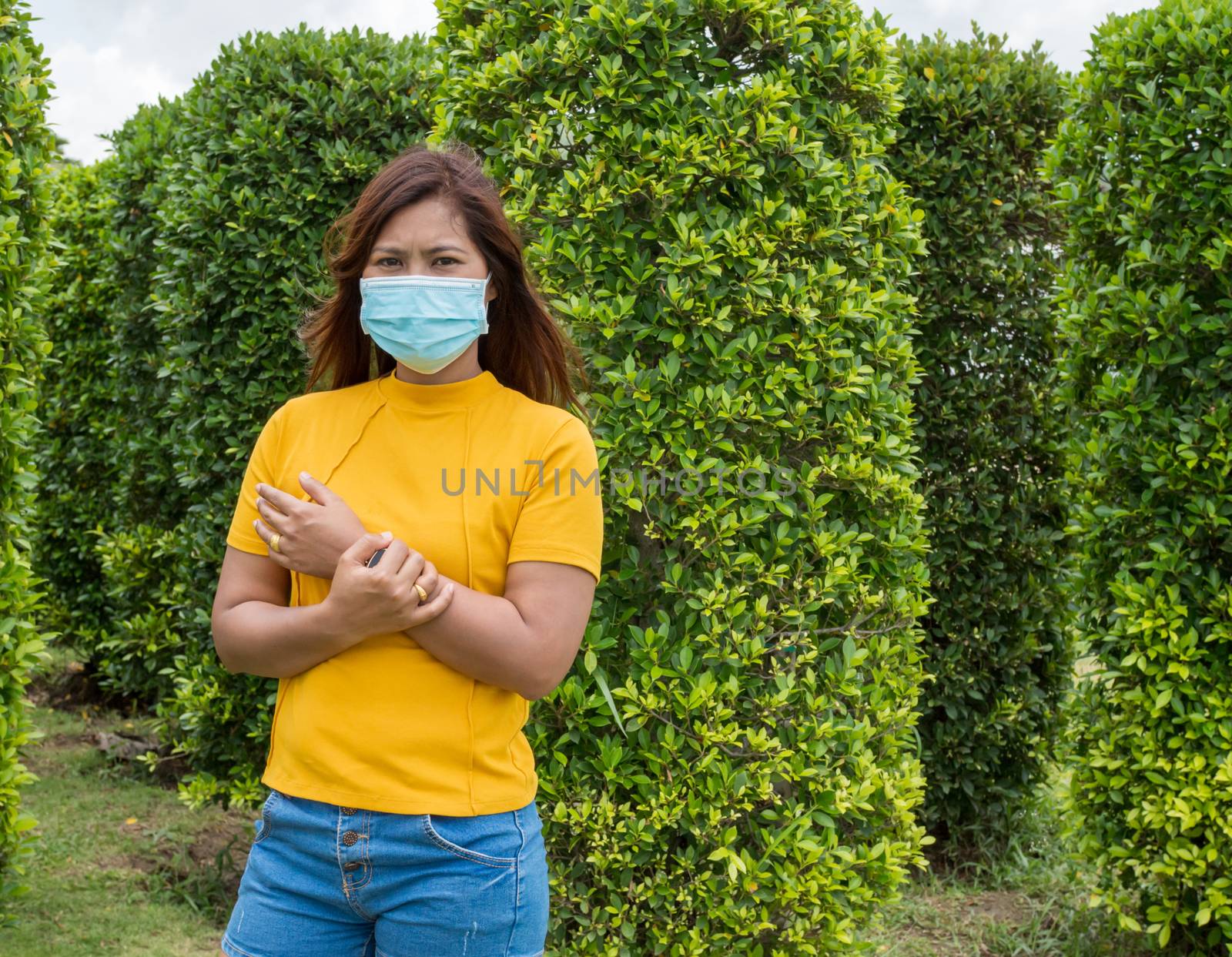 Portraits of women wearing protective masks During travel With a by Unimages2527