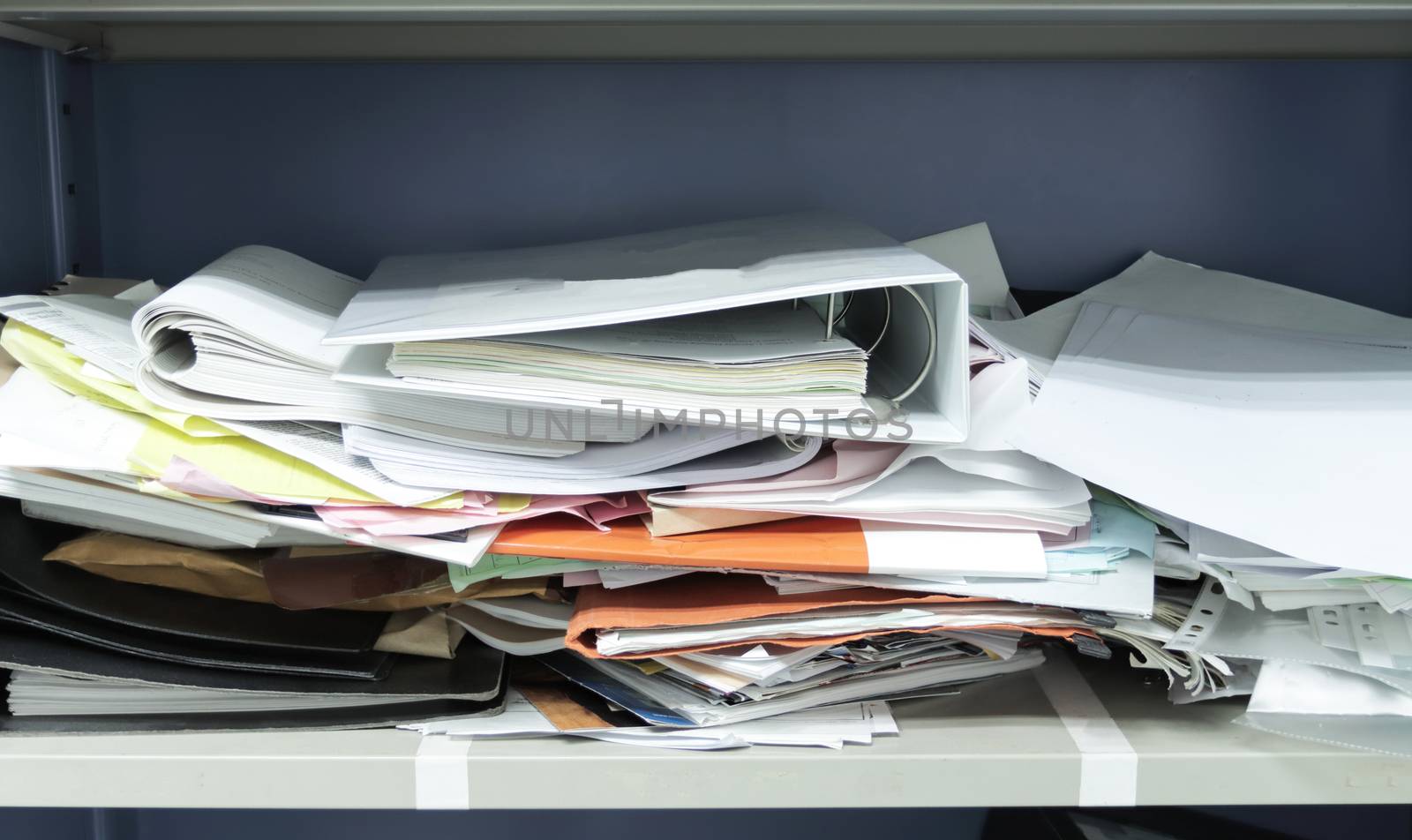 Messy file document and Office Supplies in filing cabinets at work office 