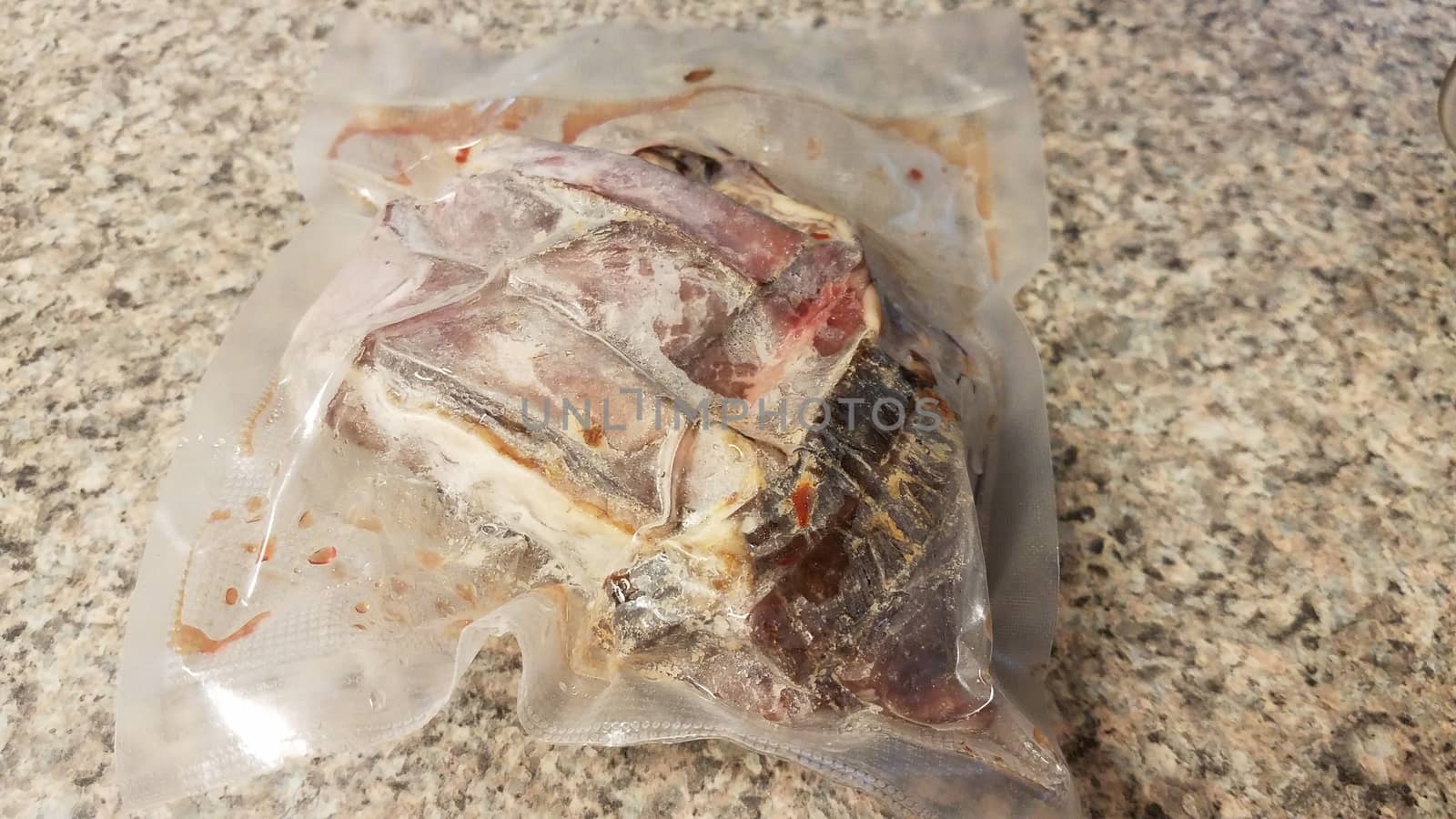 frozen beef meat in plastic bag on counter by stockphotofan1