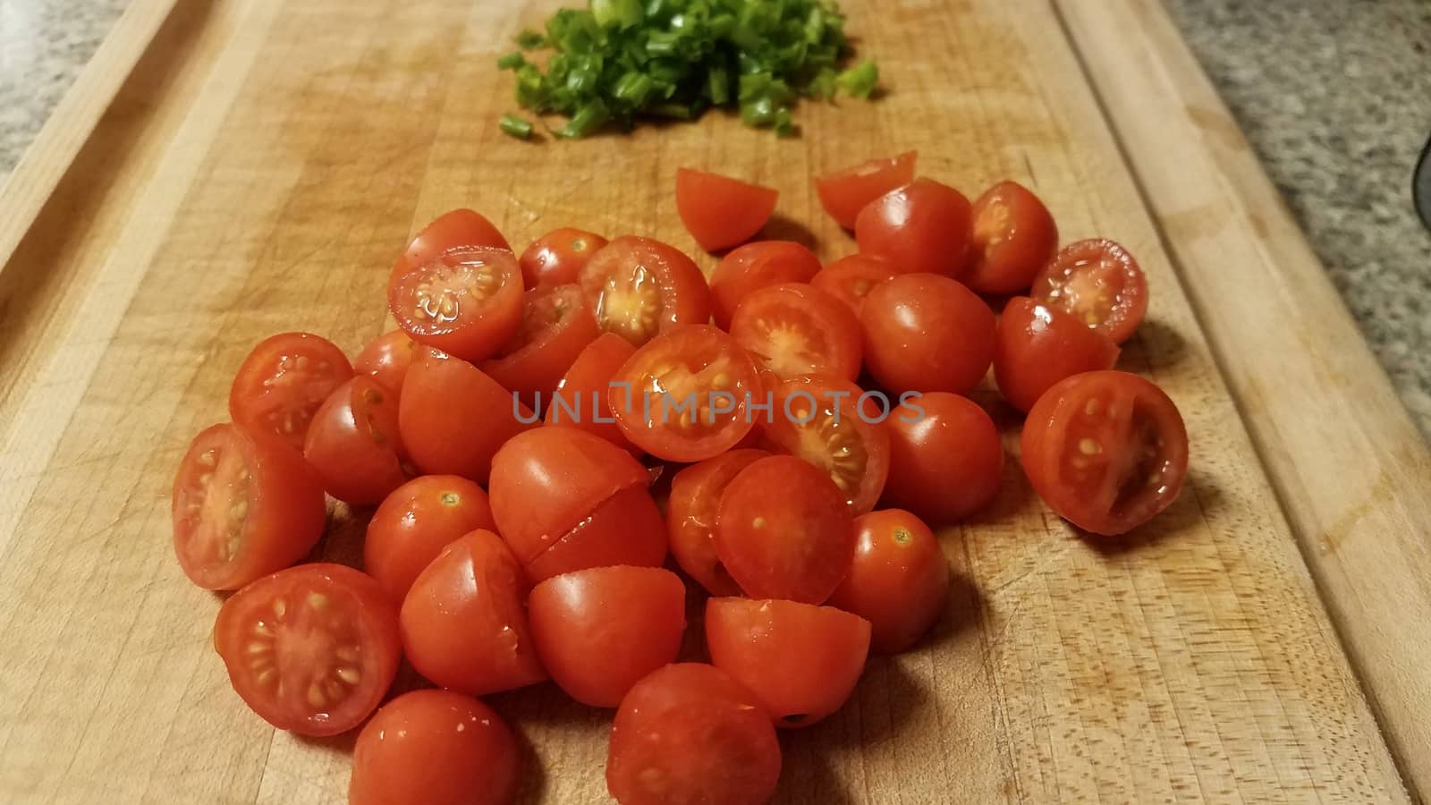 red tomatoes on cutting board with chives by stockphotofan1