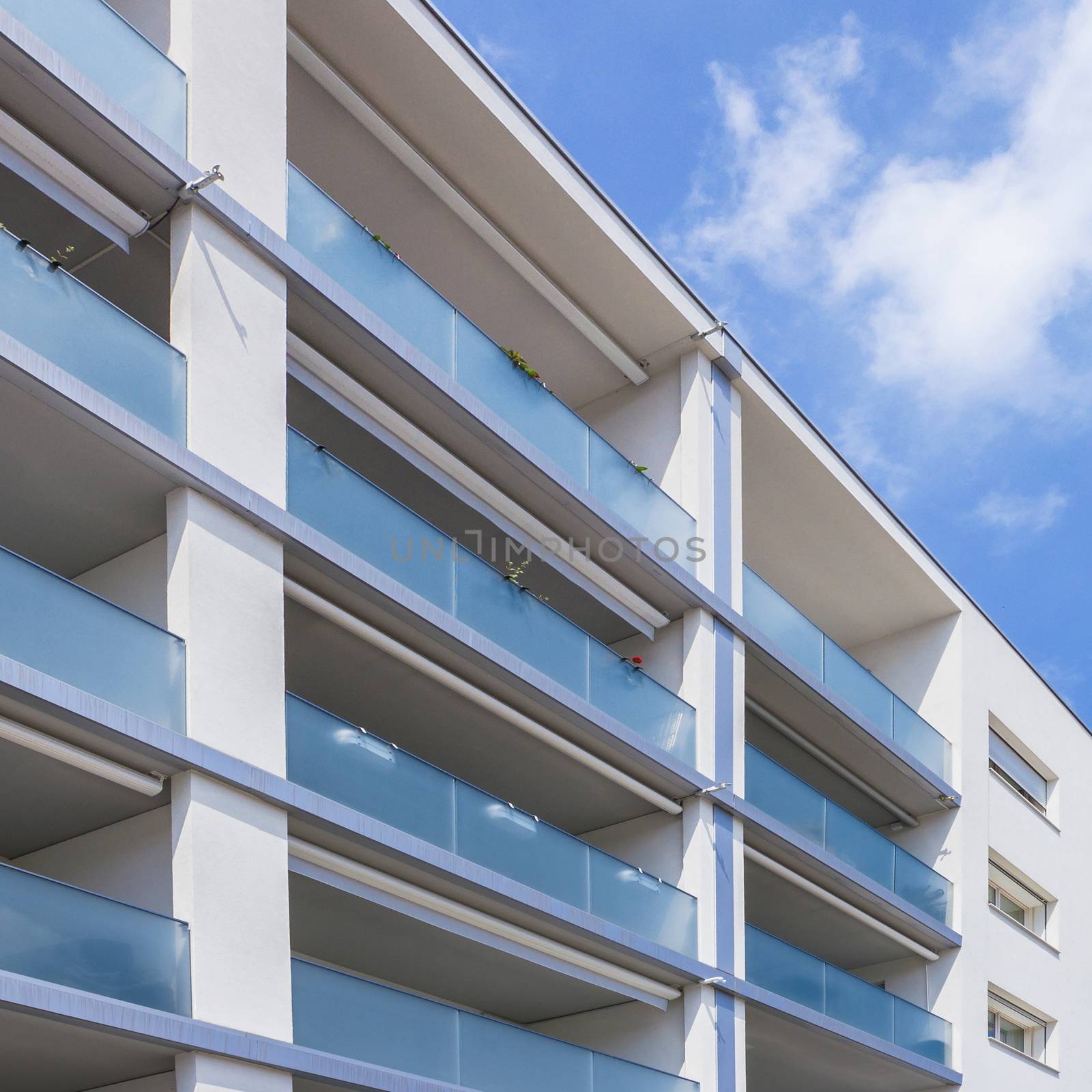 Facade of a modern apartment building on a sunny day with a blue sky. Facade of a new apartment building.