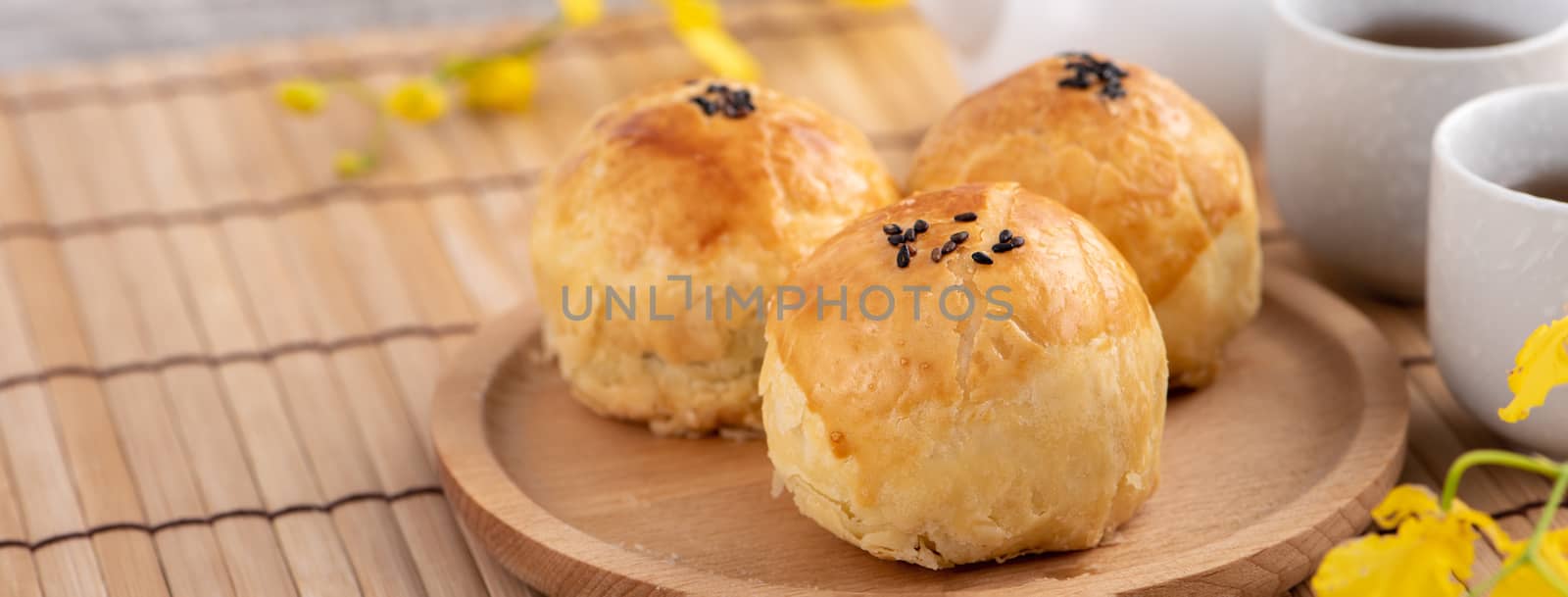 Moon cake yolk pastry, mooncake for Mid-Autumn Festival holiday, top view design concept on bright wooden table with copy space