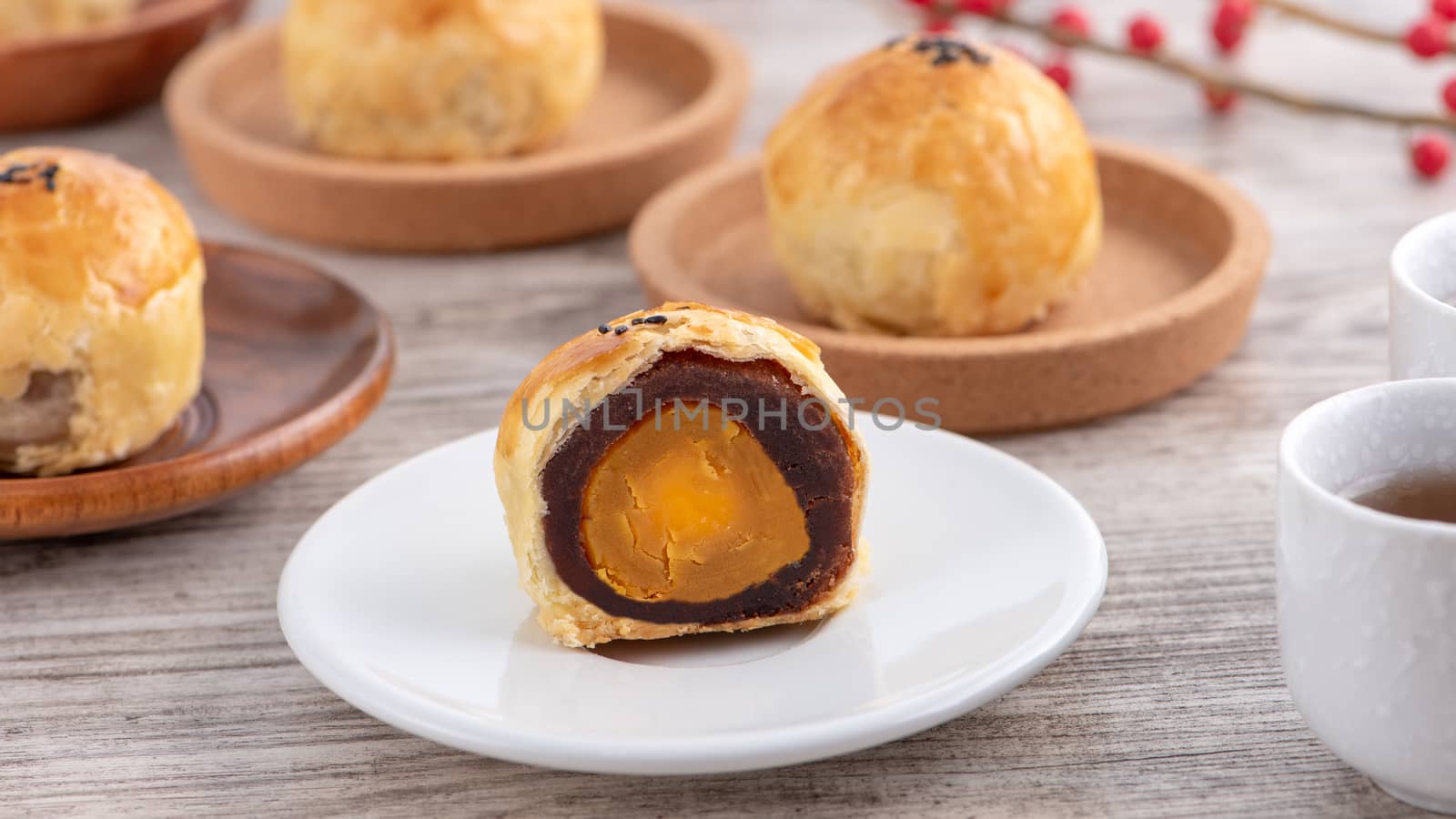 Moon cake yolk pastry, mooncake for Mid-Autumn Festival holiday, top view design concept on bright wooden table with copy space