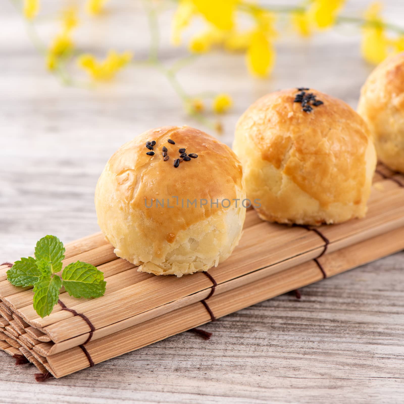 Moon cake yolk pastry, mooncake for Mid-Autumn Festival holiday, top view design concept on bright wooden table with copy space