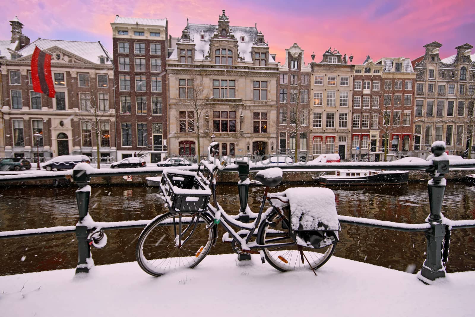 Snowy Amsterdam in winter in the Netherlands at sunset by devy
