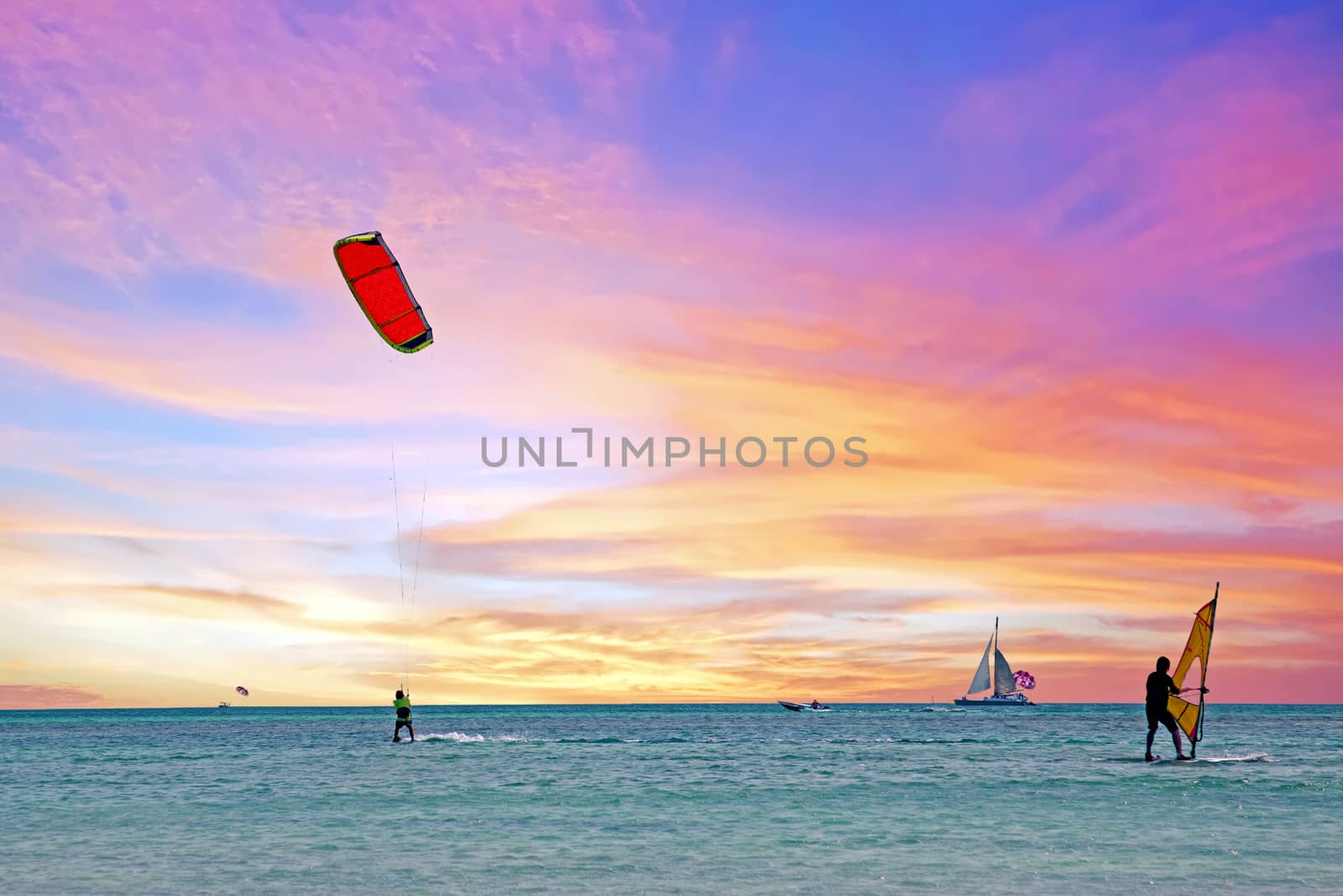 Watersports at Palm Beach on Aruba island in the Caribbean Sea at sunset