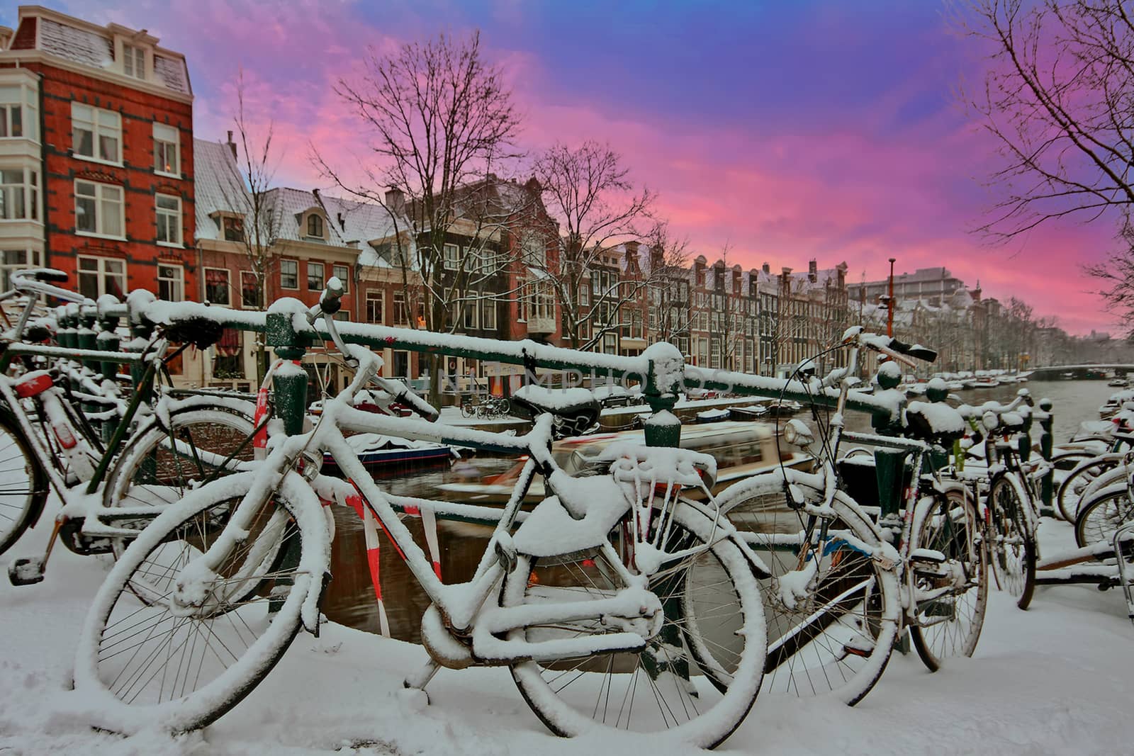 City scenic from snowy Amsterdam in the Netherlands at sunset