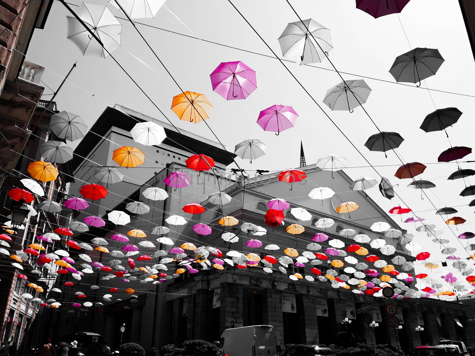 Genova, Italy - 0/29/2020: Multicolored umbrellas against the sky, street decorated. LGBT flag. Rainbow love concept. Human rights and tolerance.