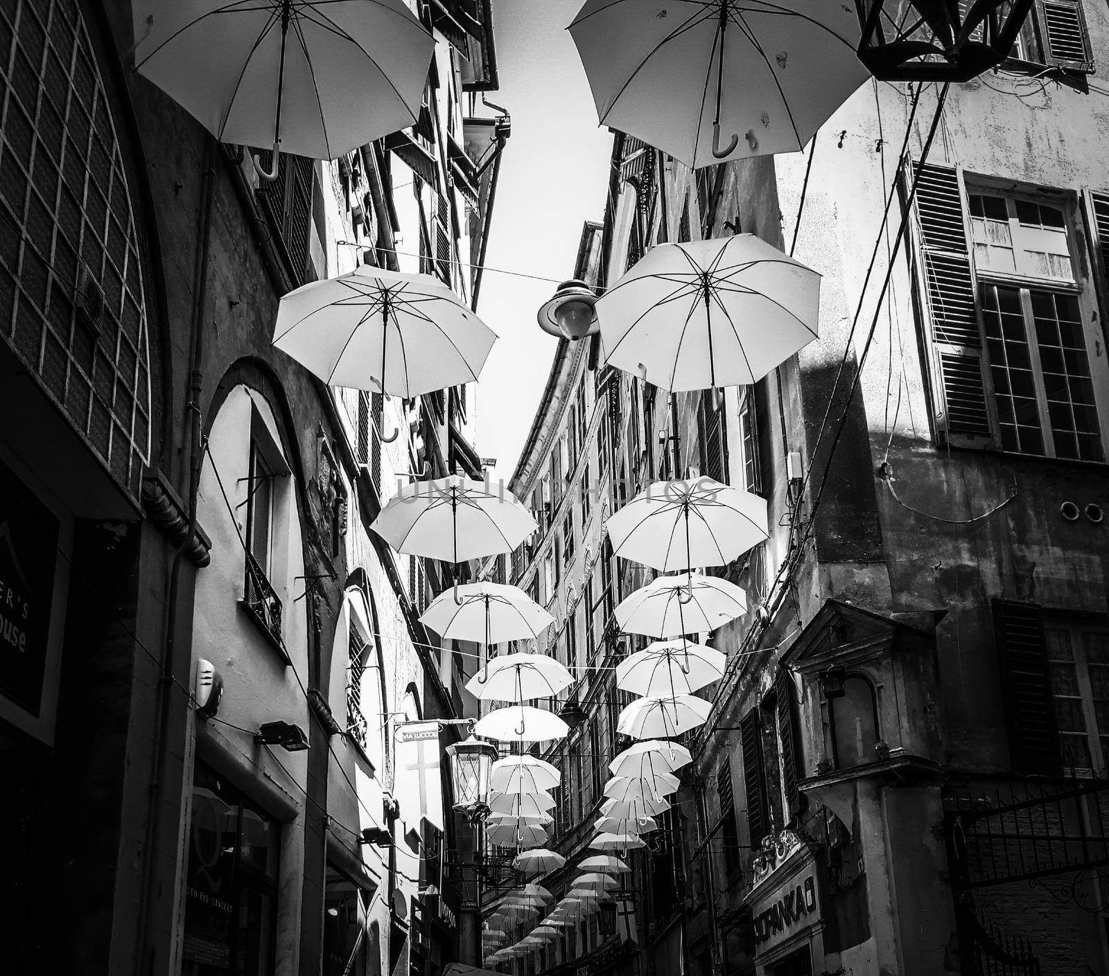 Genova, Italy - 0/29/2020: Multicolored umbrellas against the sky, street decorated. LGBT flag. Rainbow love concept. Human rights and tolerance.