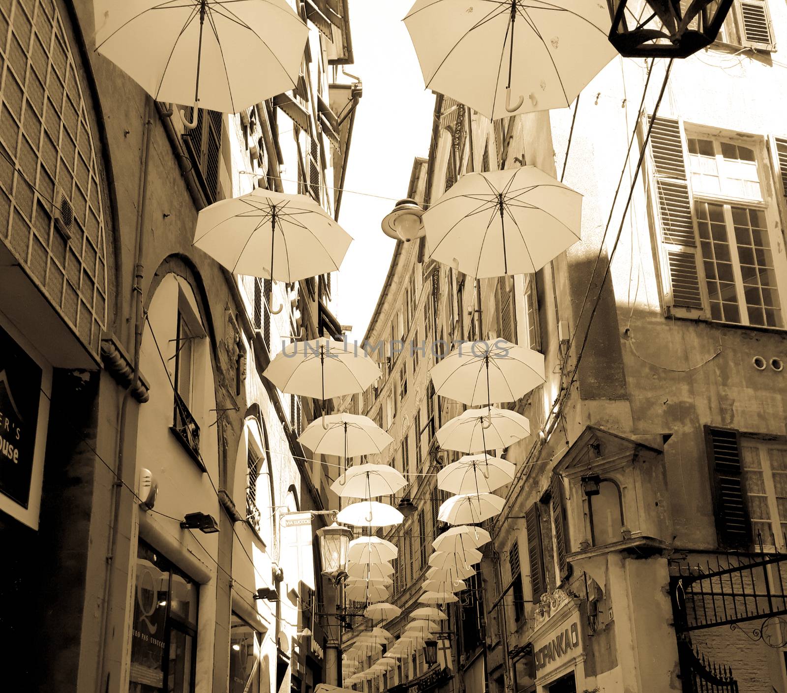 Genova, Italy - 0/29/2020: Multicolored umbrellas against the sky, street decorated. LGBT flag. Rainbow love concept. Human rights and tolerance.