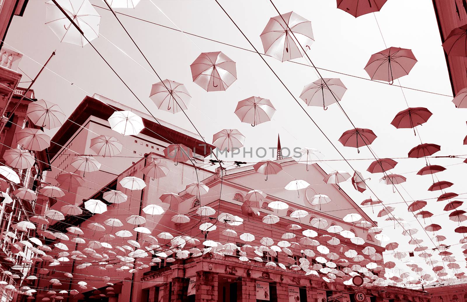 Genova, Italy - 0/29/2020: Multicolored umbrellas against the sky, street decorated. LGBT flag. Rainbow love concept. Human rights and tolerance.