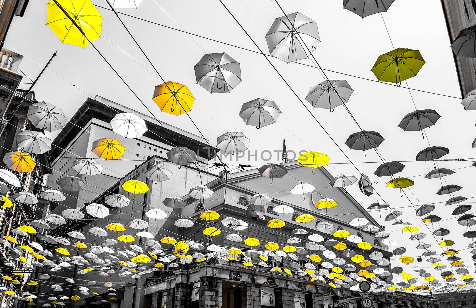 Genova, Italy - 0/29/2020: Multicolored umbrellas against the sky, street decorated. LGBT flag. Rainbow love concept. Human rights and tolerance.