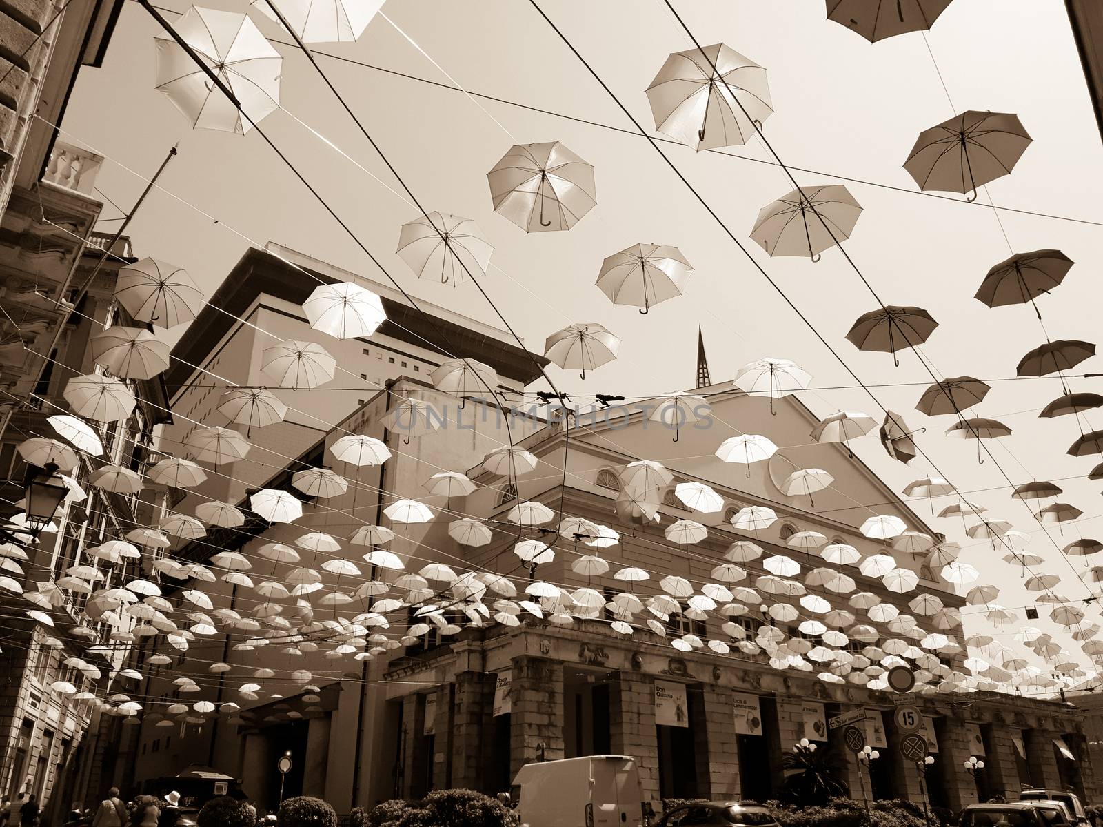 Genova, Italy - 0/29/2020: Multicolored umbrellas against the sky, street decorated. LGBT flag. Rainbow love concept. Human rights and tolerance.