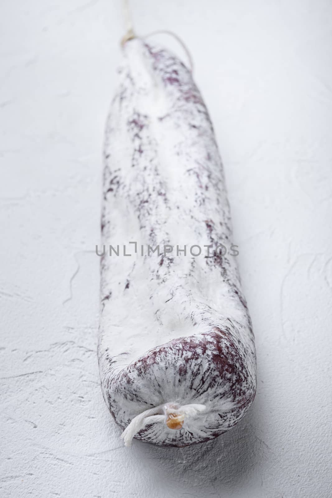 Longaniza spanish salami sausage on white background.