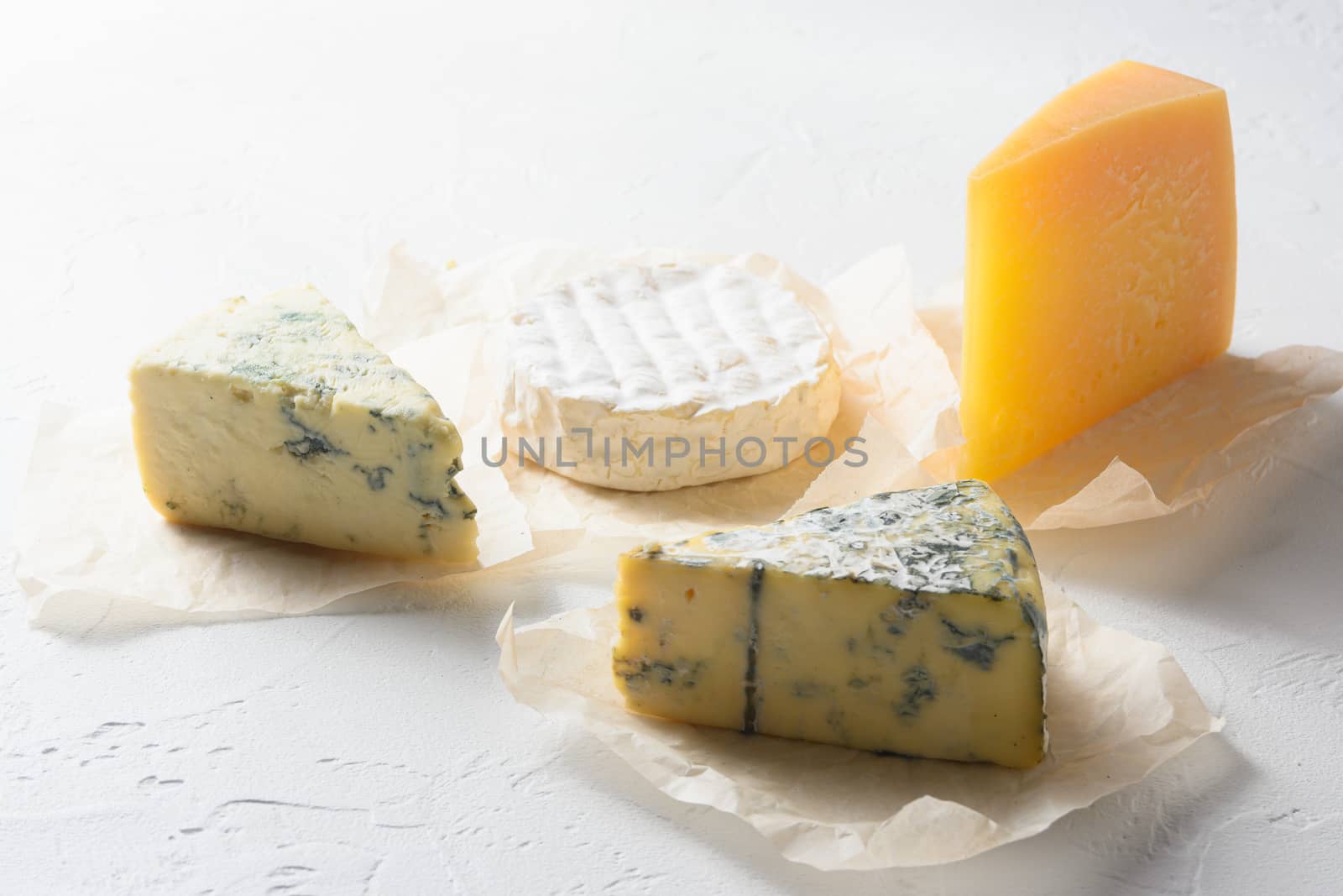 Cheese : yellow Maasdam, white Camembert and blue cheese Dor Blue on white background. Copy space. Concept serving cheese.