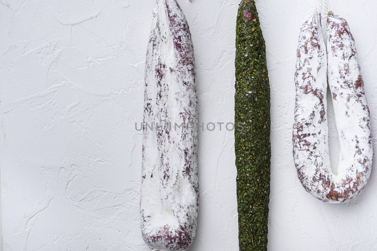 Chorizo and fuet salami on white background.