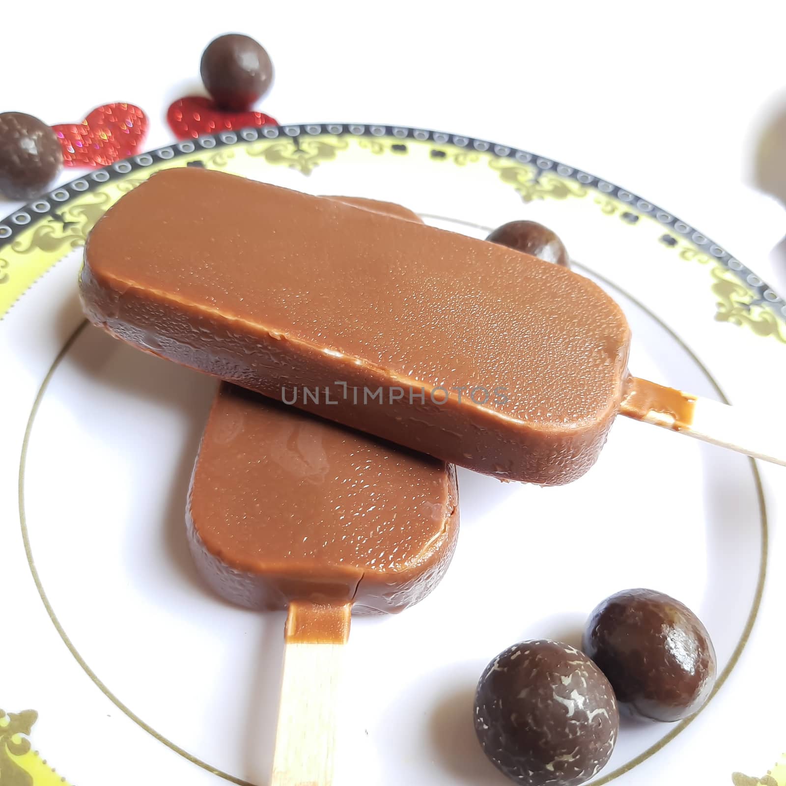 Delicious two chocolate icecream bar with chocolate ball in white plate plated beautifully by AnithaVikram