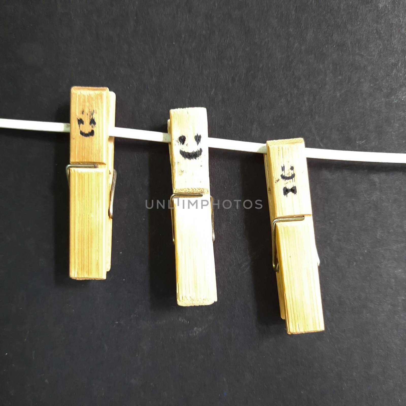 Smileys picture drawn in Hanging clip placed with wire in black paper for backgrounds and template to use
