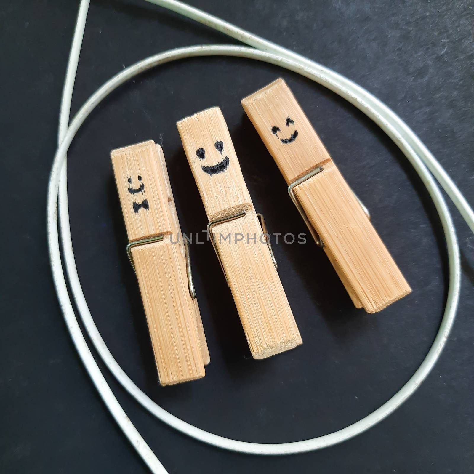 Smileys picture drawn in Hanging clip placed with wire in black paper for backgrounds and template to use