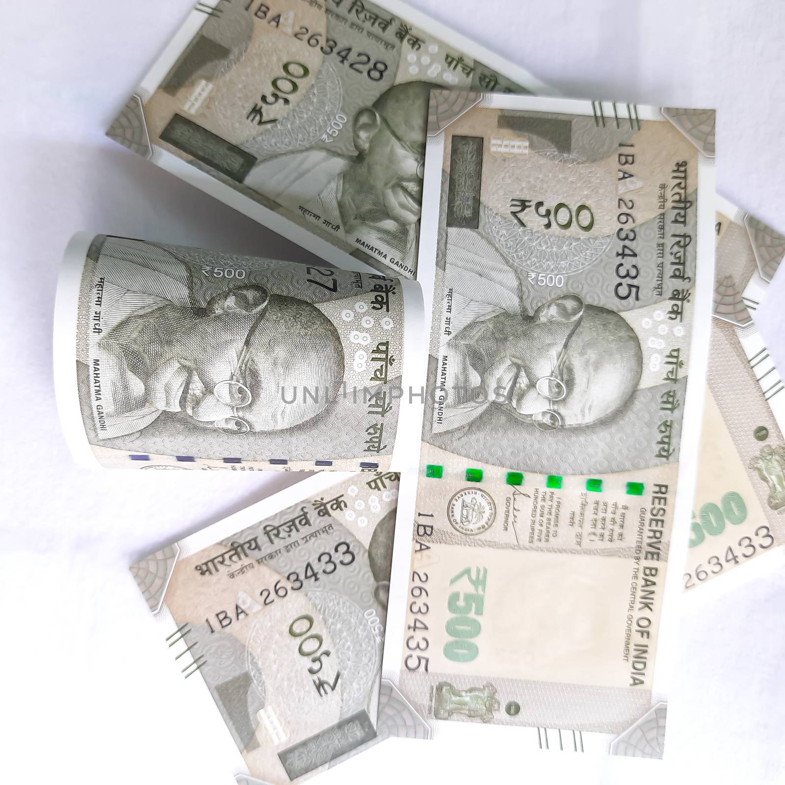 indian new currency 500 rupees with rubber band spread randomly took close view of gandhi face