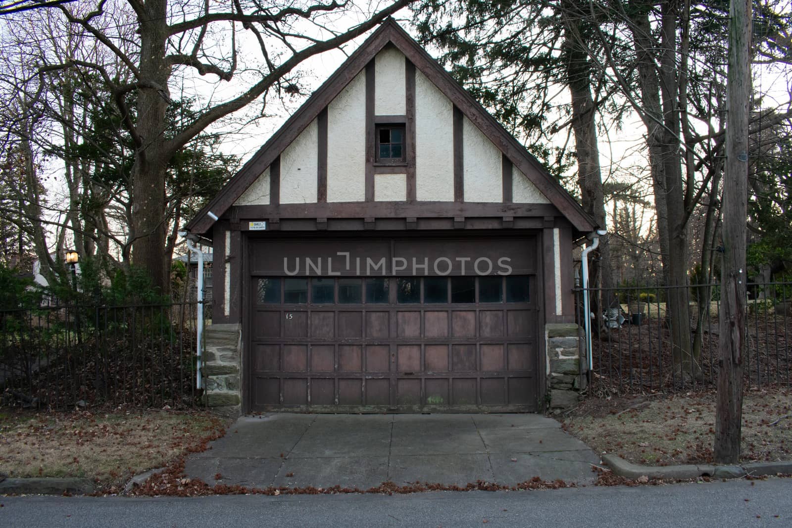 An Old-Fashioned Brown and White Garage on a Cloudy Day
