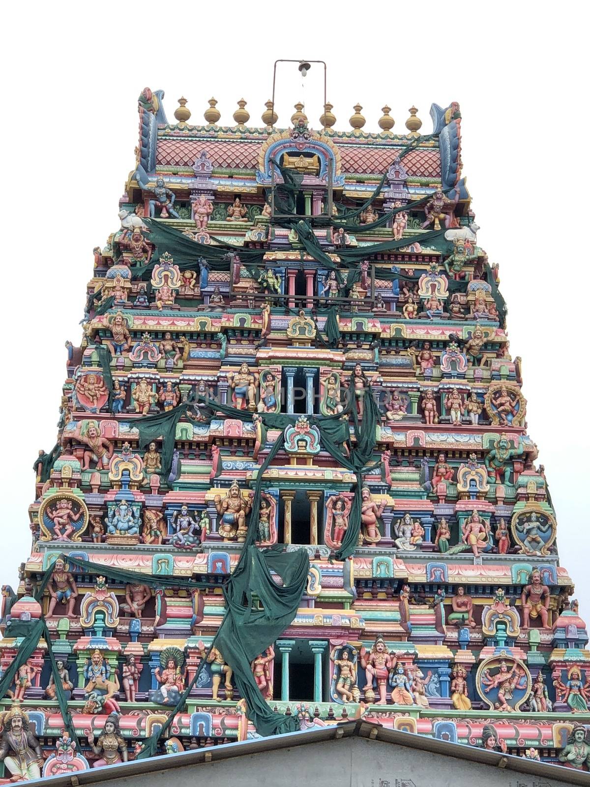 Temple with beautiful goupuram and sculptures in it with clear sky background