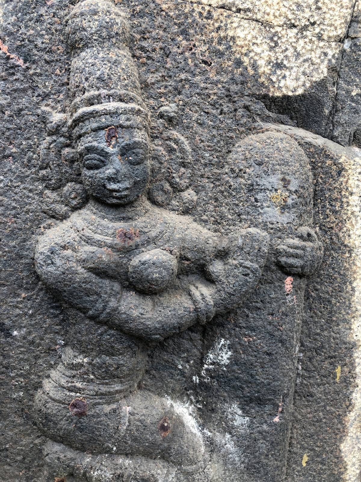 Goddess holding the Shiva Linga sculpture. Bas relief sculpture carved in the walls of Shiva temple at Tamil nadu by prabhakaran851